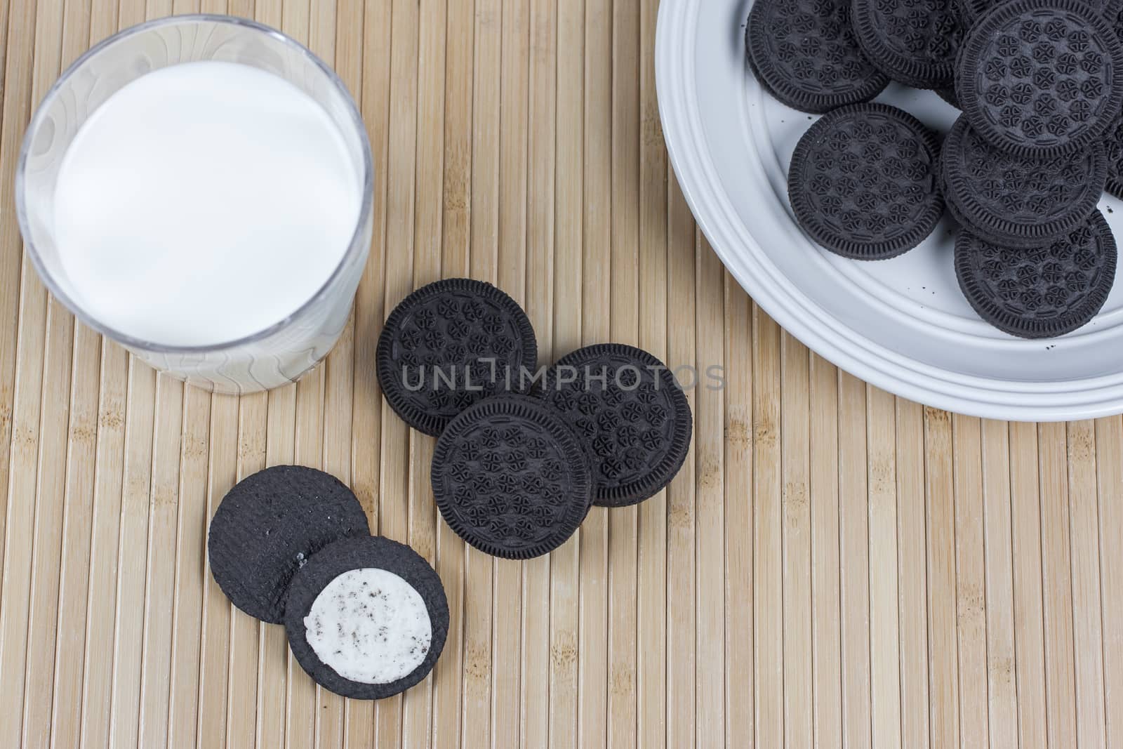 Chcoclate Sandwich Cookies and Milk by SouthernLightStudios
