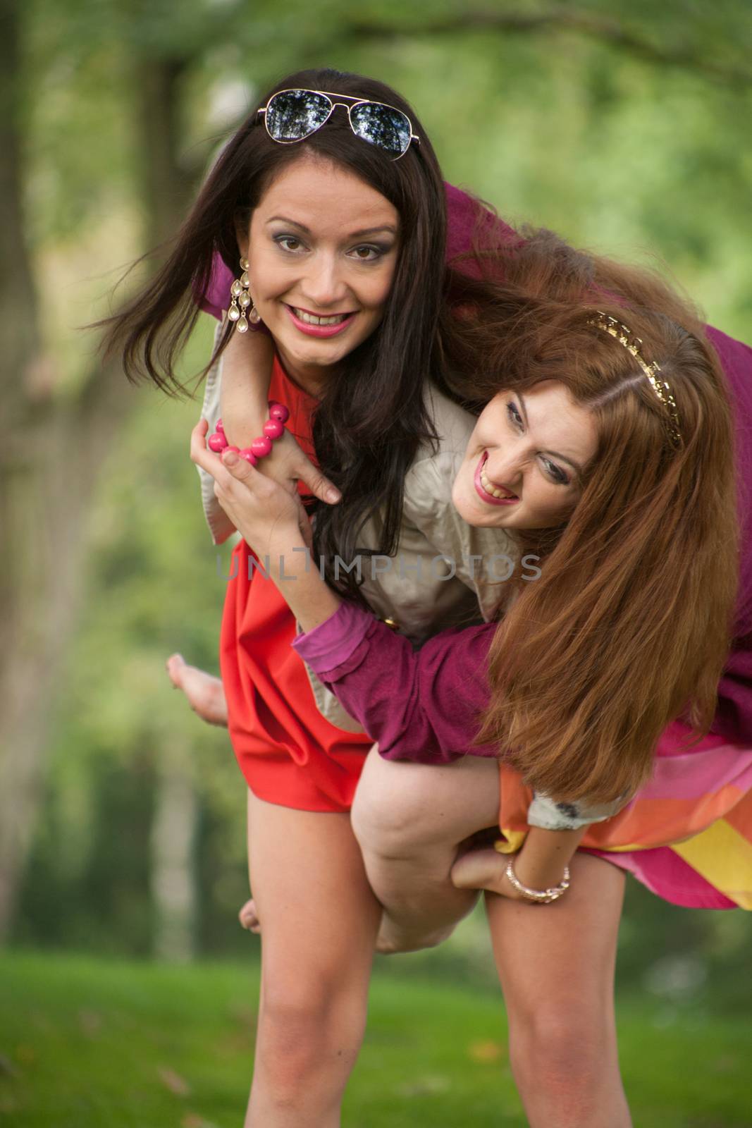 Two girls are having a lot of fun in the forest