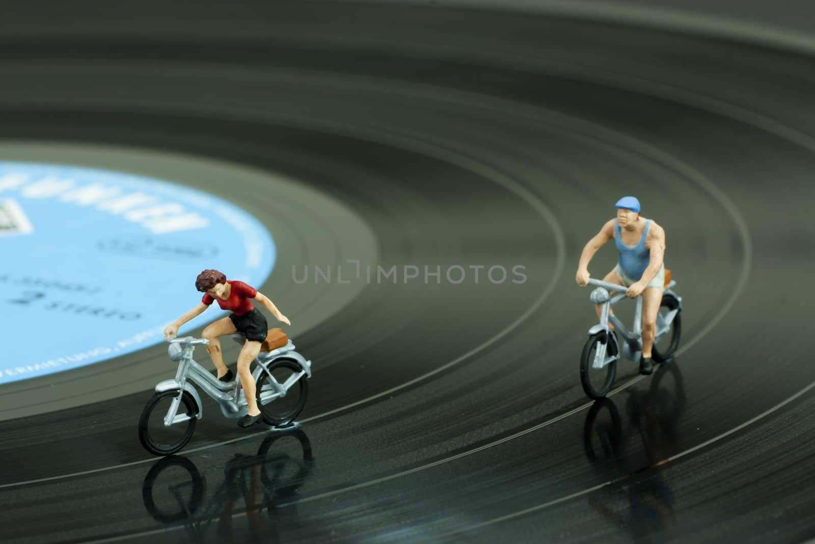 Two model people in cycle race by christopherhall