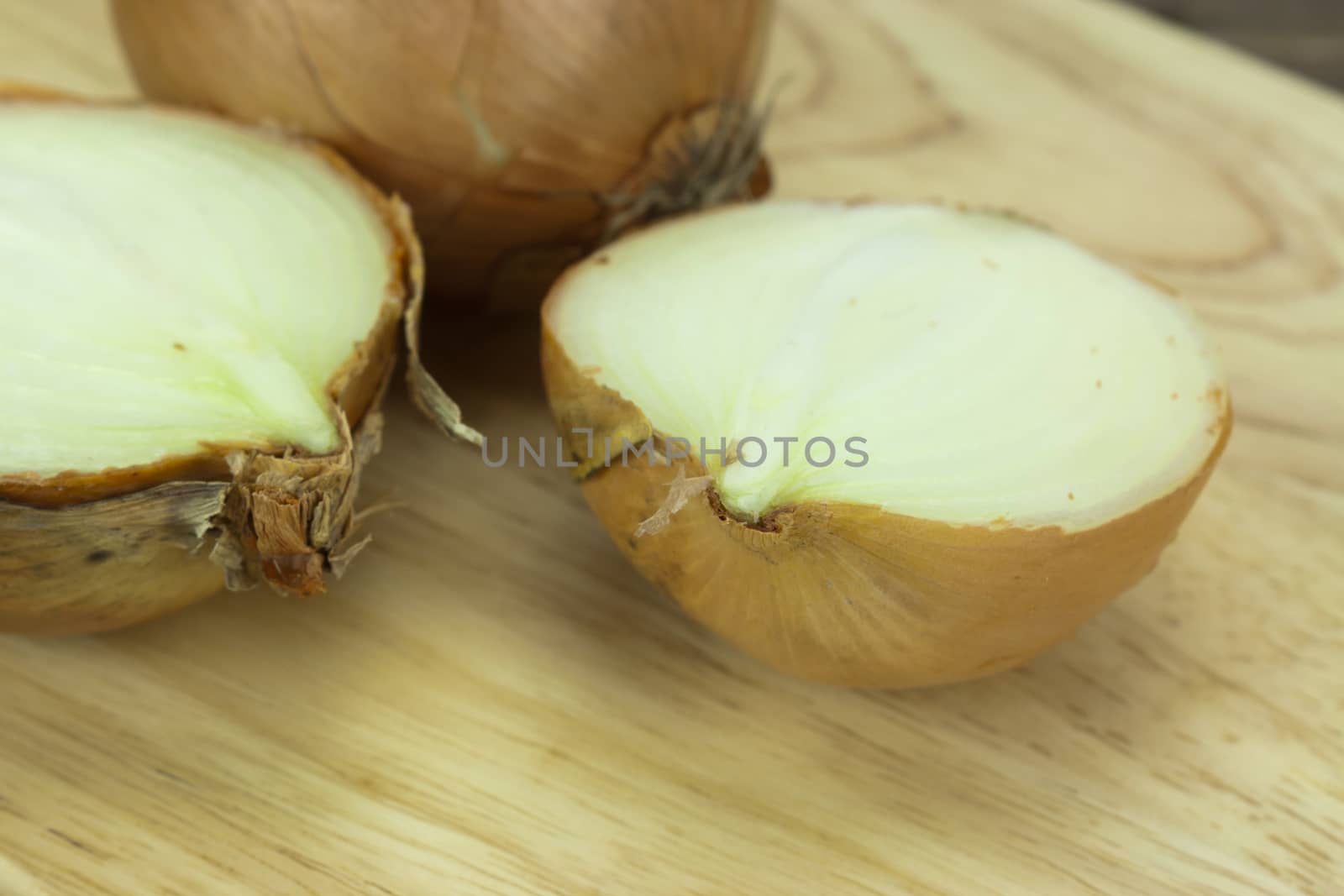 Onion on a wooden chopping board with knife