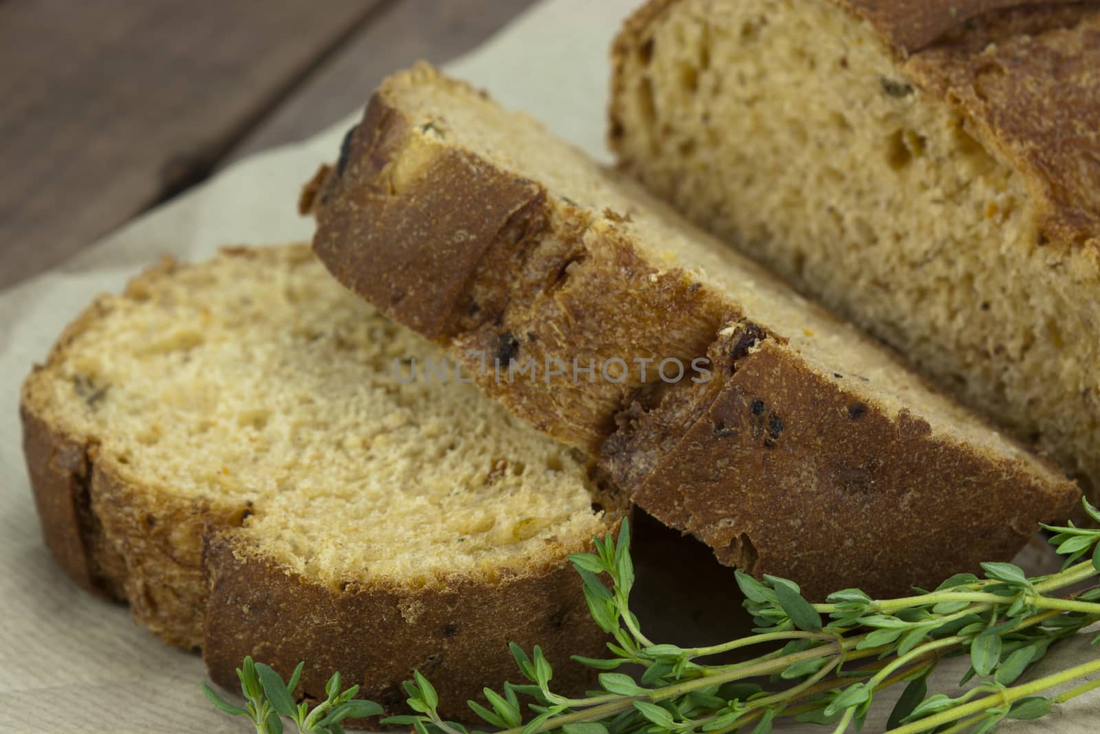 Wholemeal bread on brown paper by christopherhall