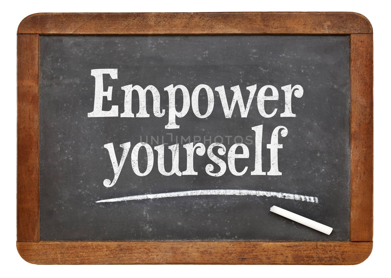 Empower yourself motivational phrase - text on an isolated  vintage slate blackboard