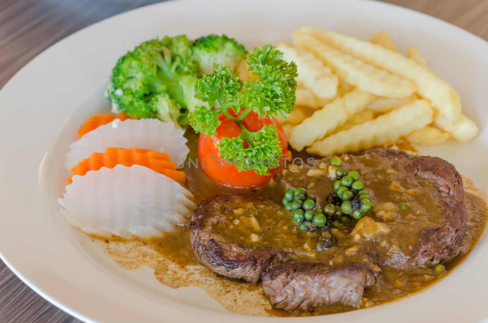 close up beef steak with green peppercorn sauce