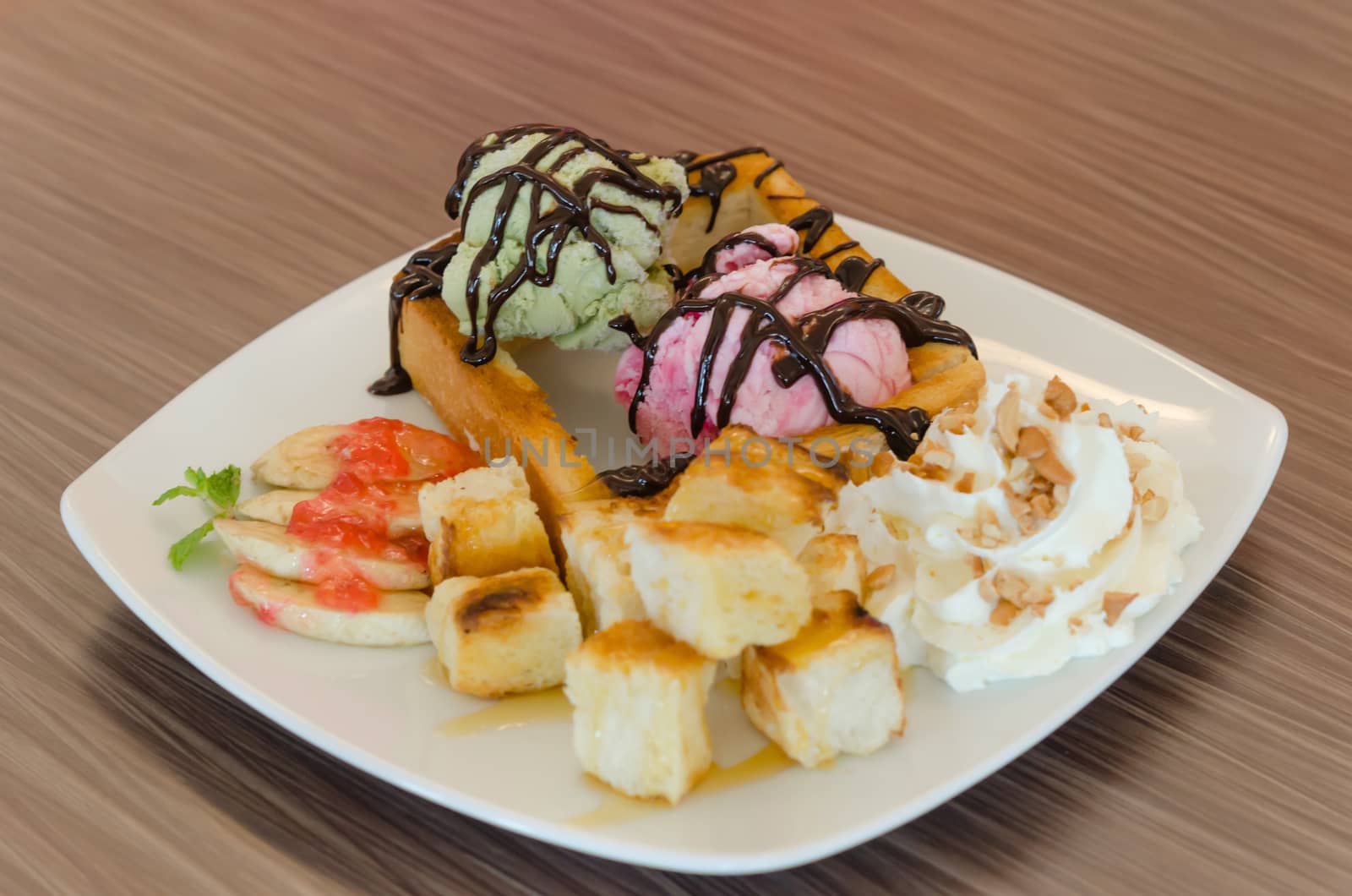 Honey toast and whipping cream with chocolate  sauce and ice cream