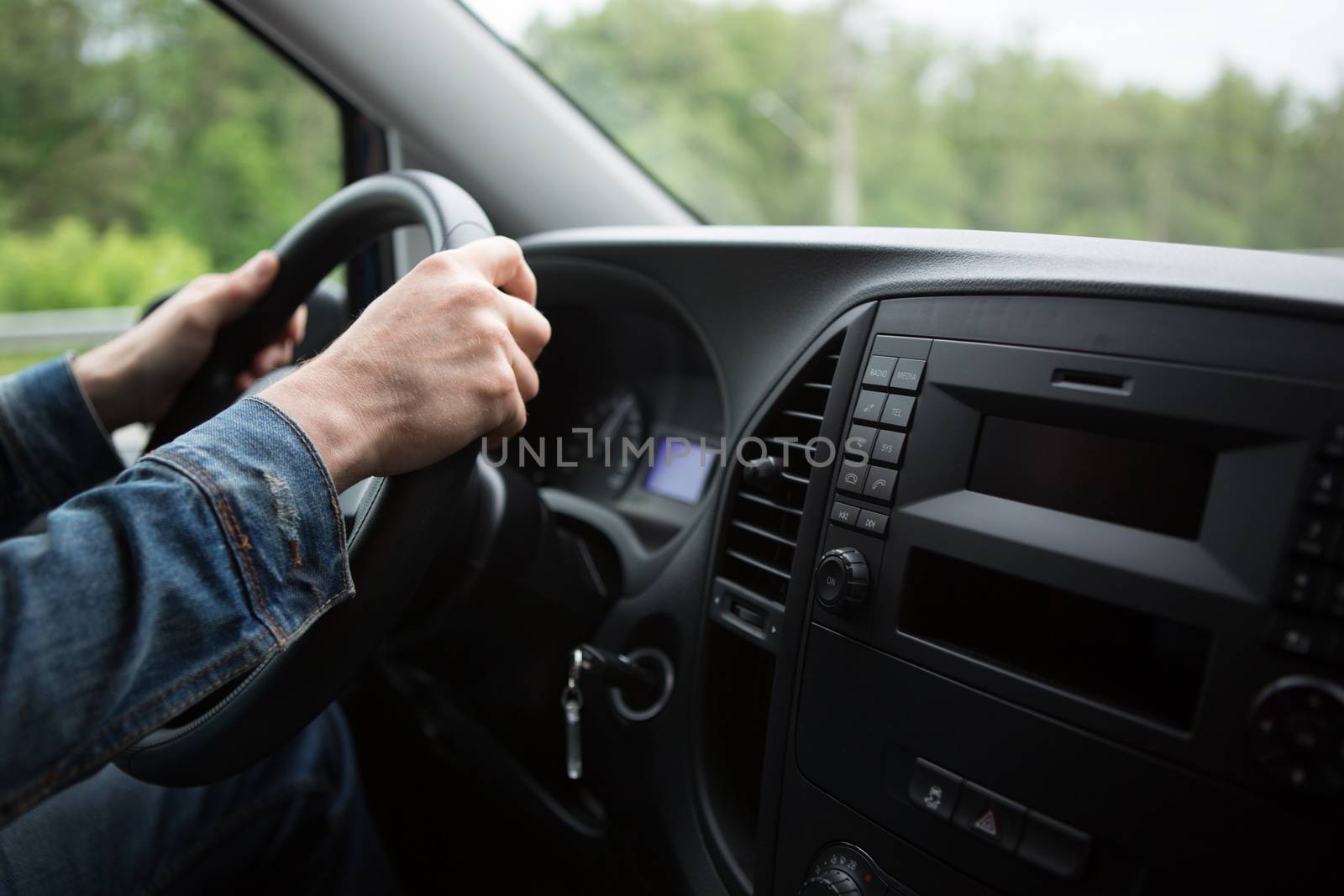 hand close up of a man driving a car