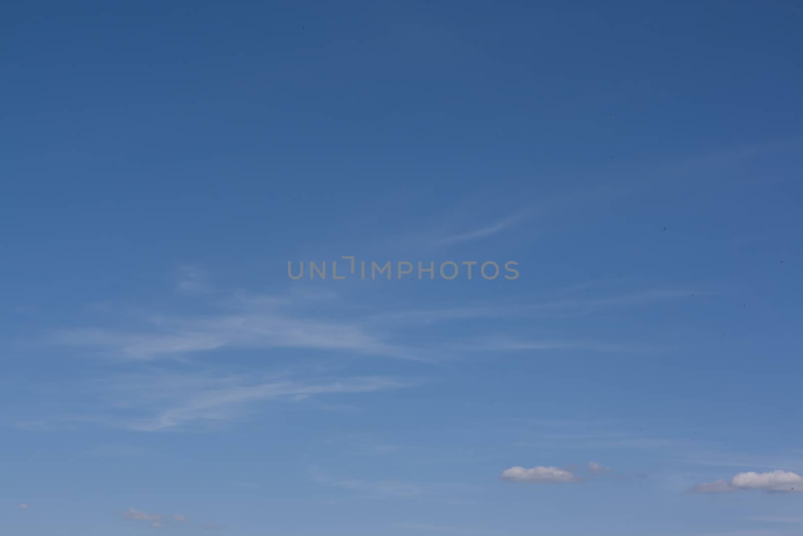 Small white clouds on blue sky by christopherhall