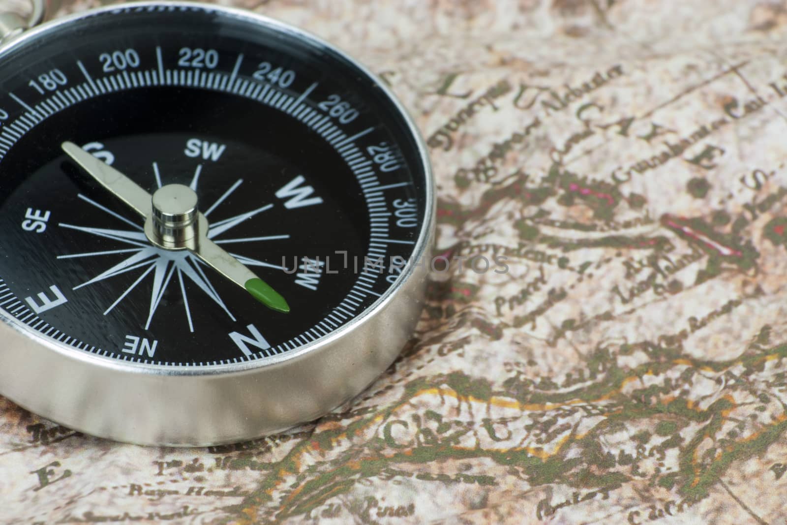 Close up of a compass on an old map