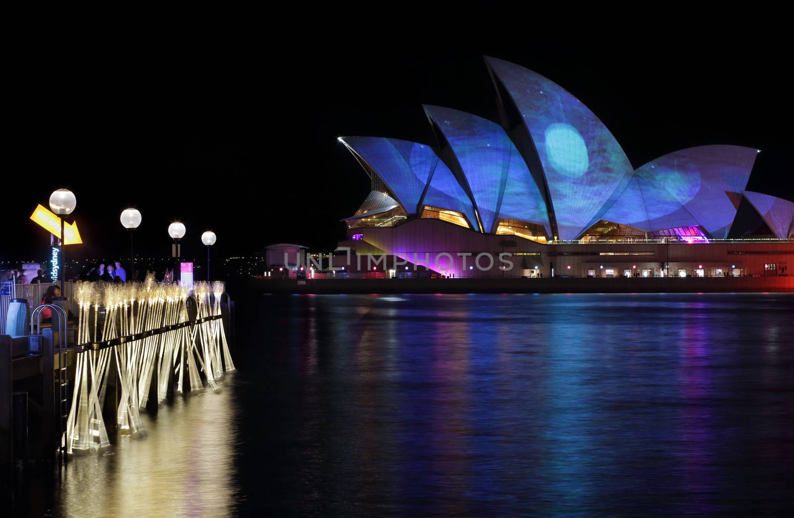 SYDNEY, AUSTRALIA - MAY 27, 2015; The Sydney Opera House comes alive each night during Vivid Sydney.  Projectors cast coloured light and patterns onto the roof creating a spectacular display, like this blue moon starscape with coloured reflections.