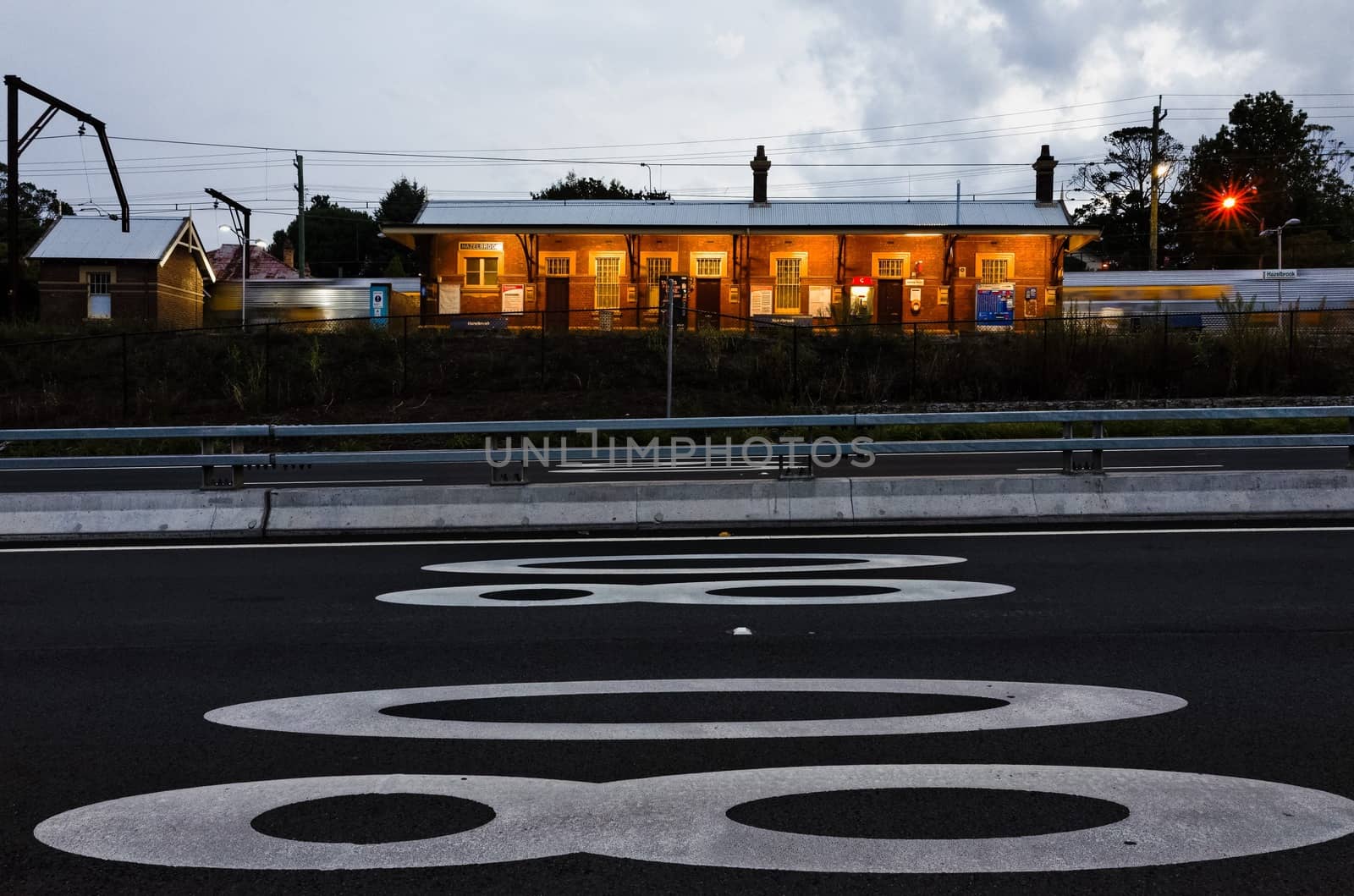 Suburban train leaving Hazelbrook train Station at dusk in the Blue Mountains, Australia.