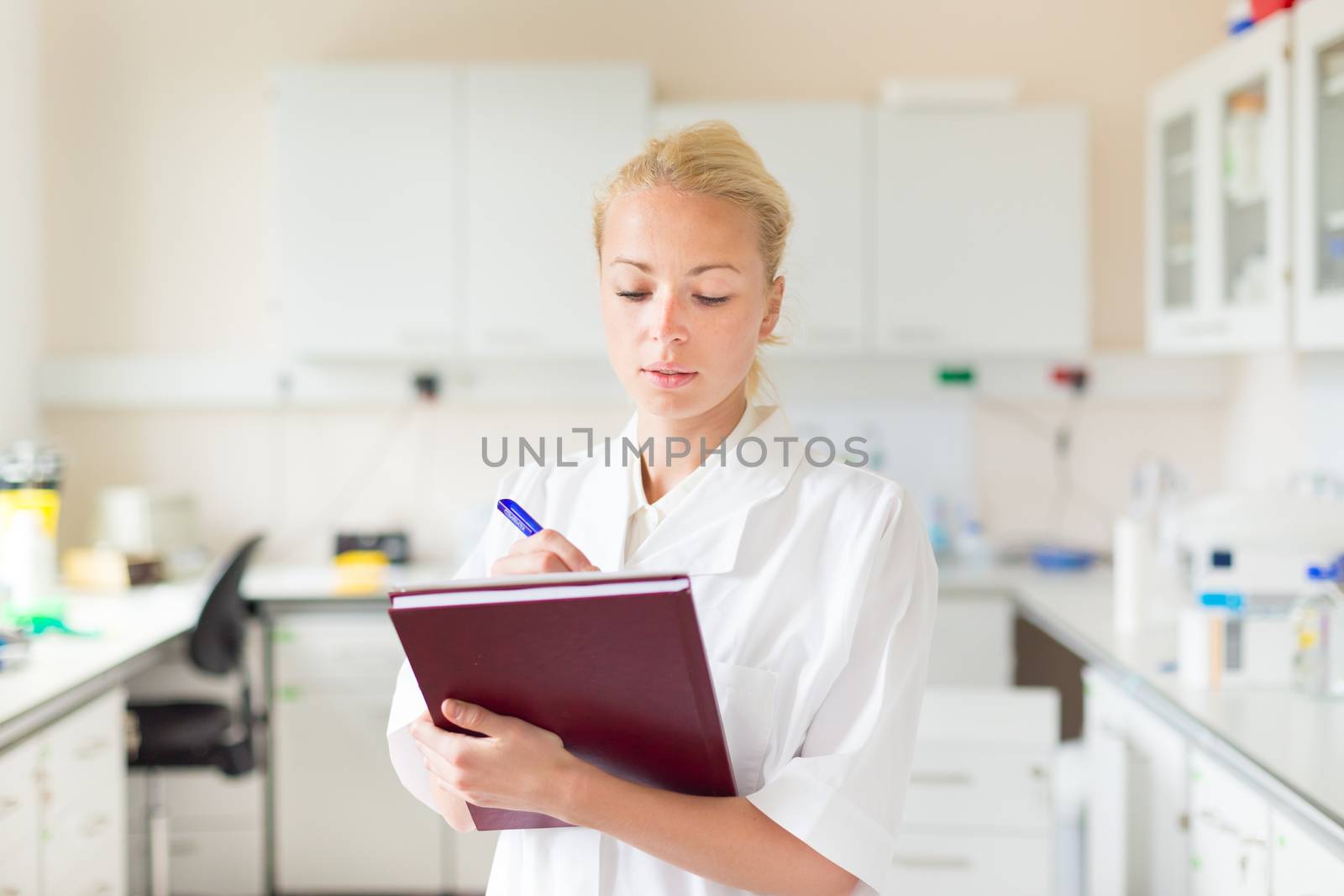 Portrait of an attractive, young, confident female health care professional in his working environment.