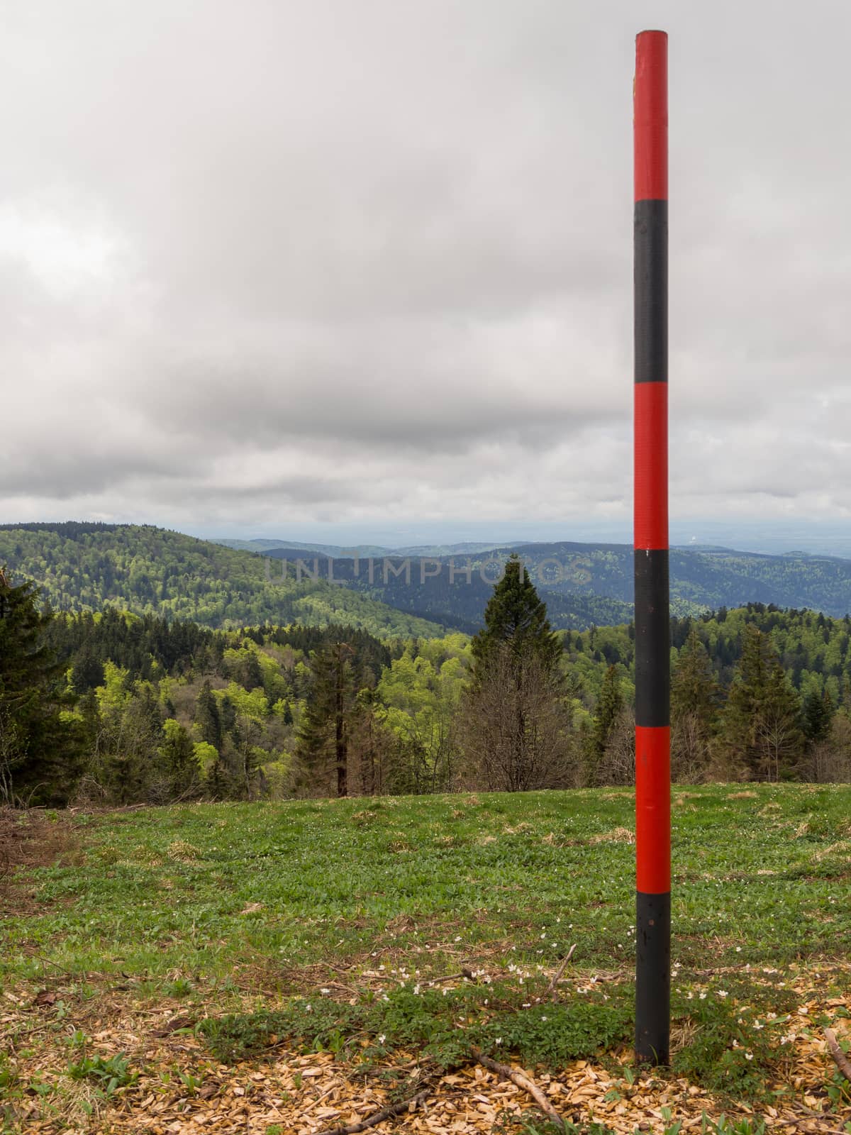 Striped pole along a path on top of the vogezen hills in France