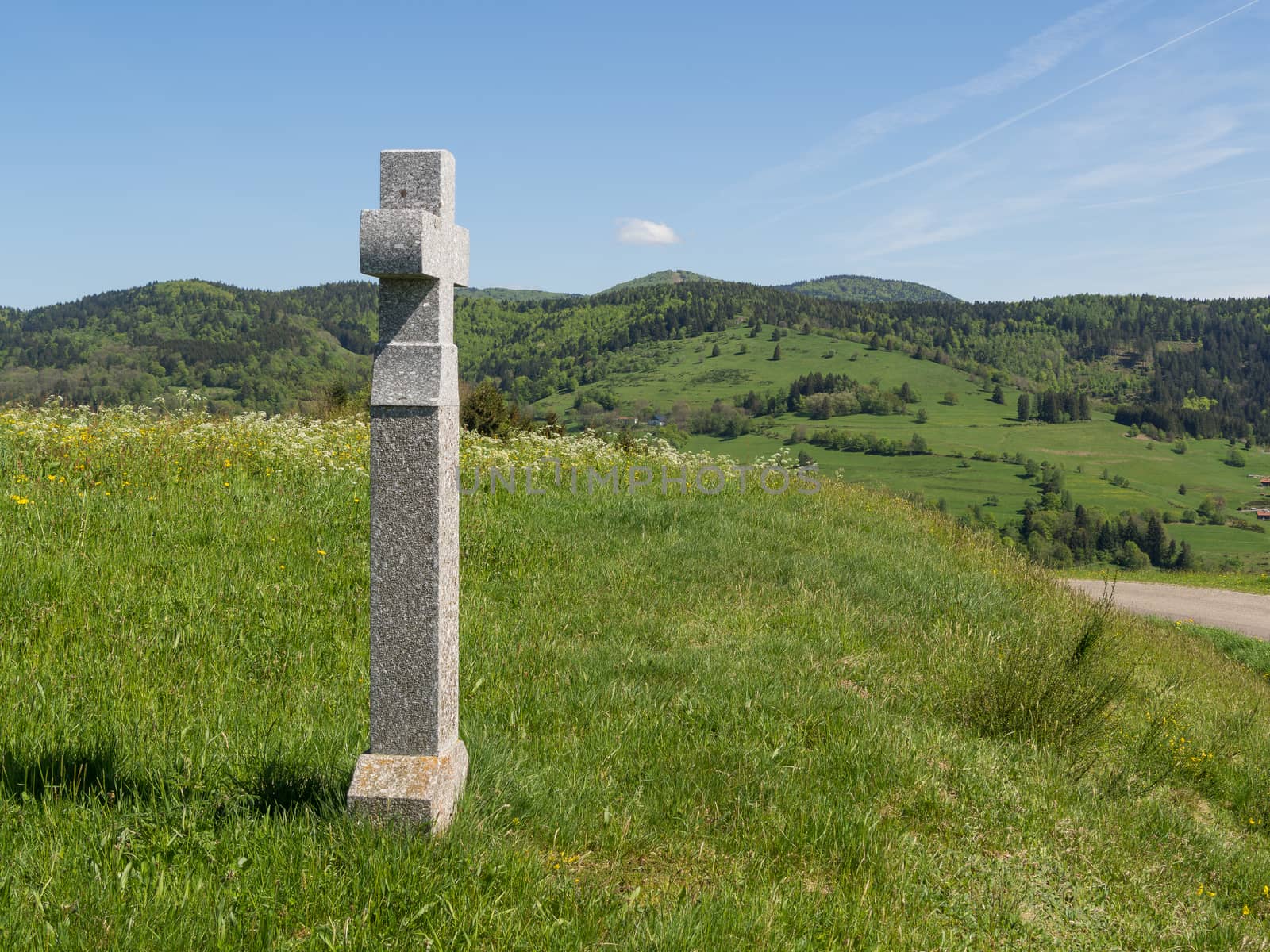 Stone religious cross on top of vosges hills by frankhoekzema