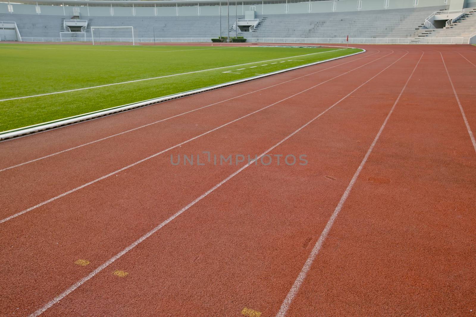 Running track with lawn yard for the athletes background