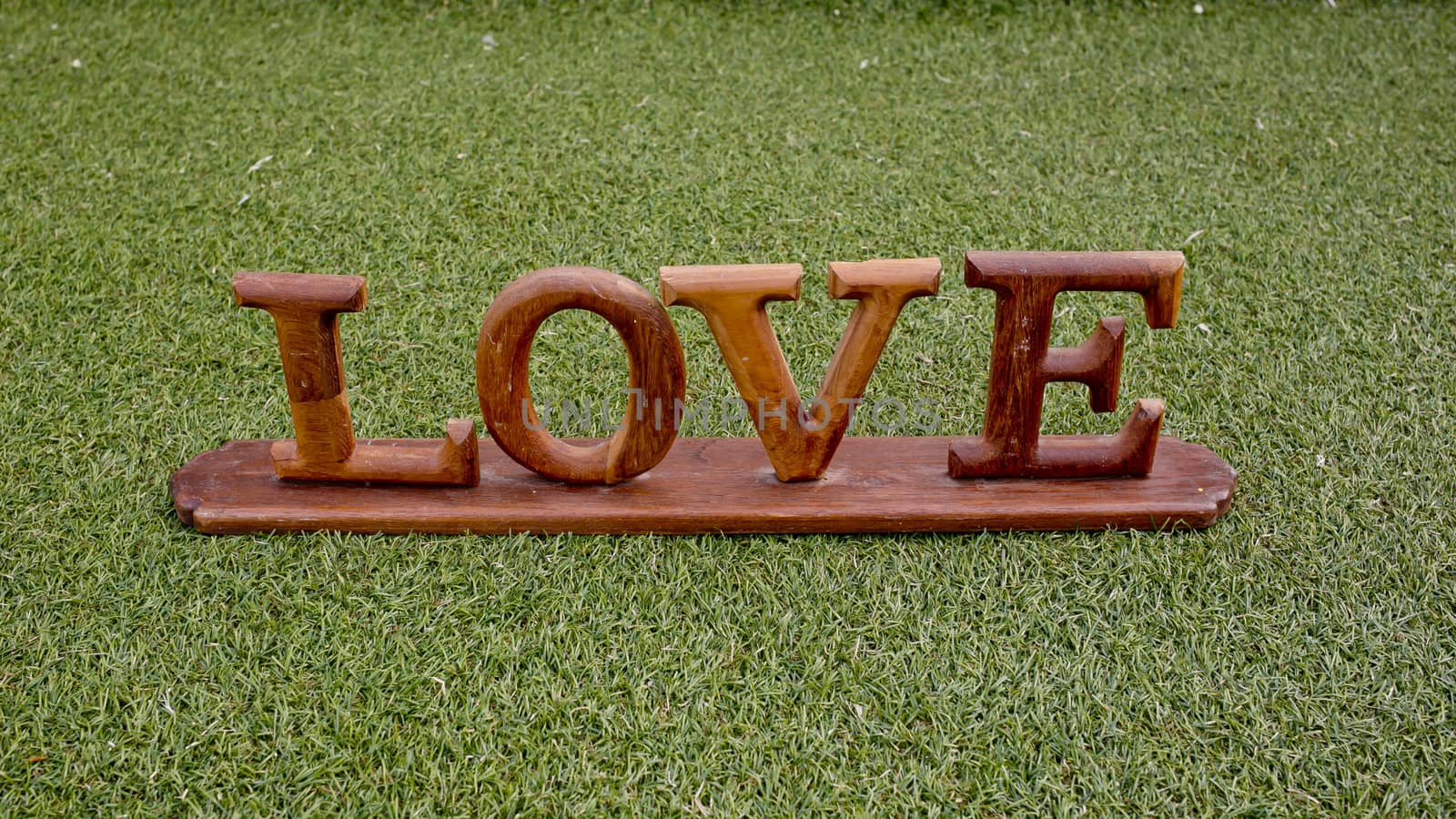 Love is in the air and on the green - Word LOVE lay on grass - Wedding day concept