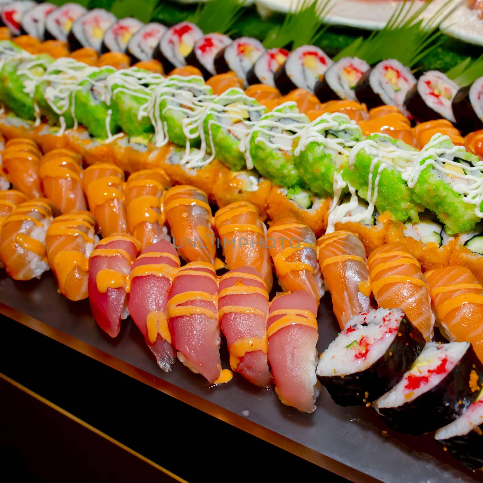 Japanese Cuisine -Buffet catering style Sushi Set in restaurant - salmon Maki Sushi and Nigiri Sushi