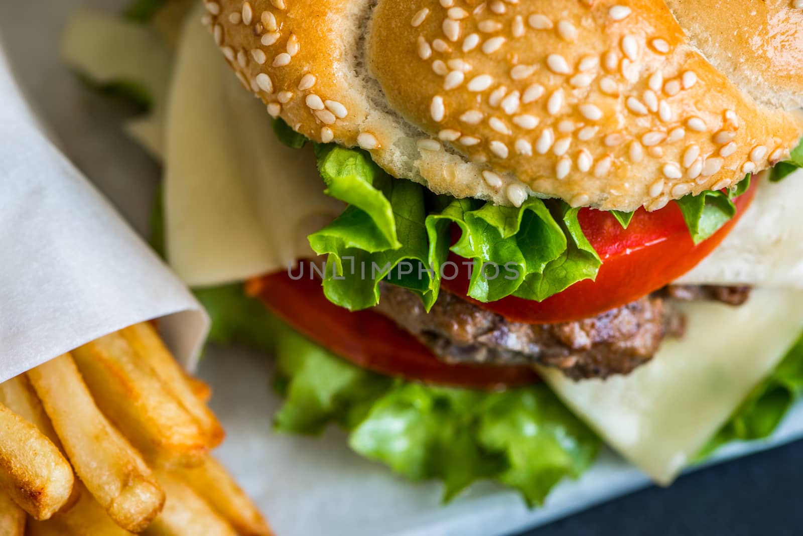 Closeup of Homemade Hamburger with Fresh Vegetables and French Fries