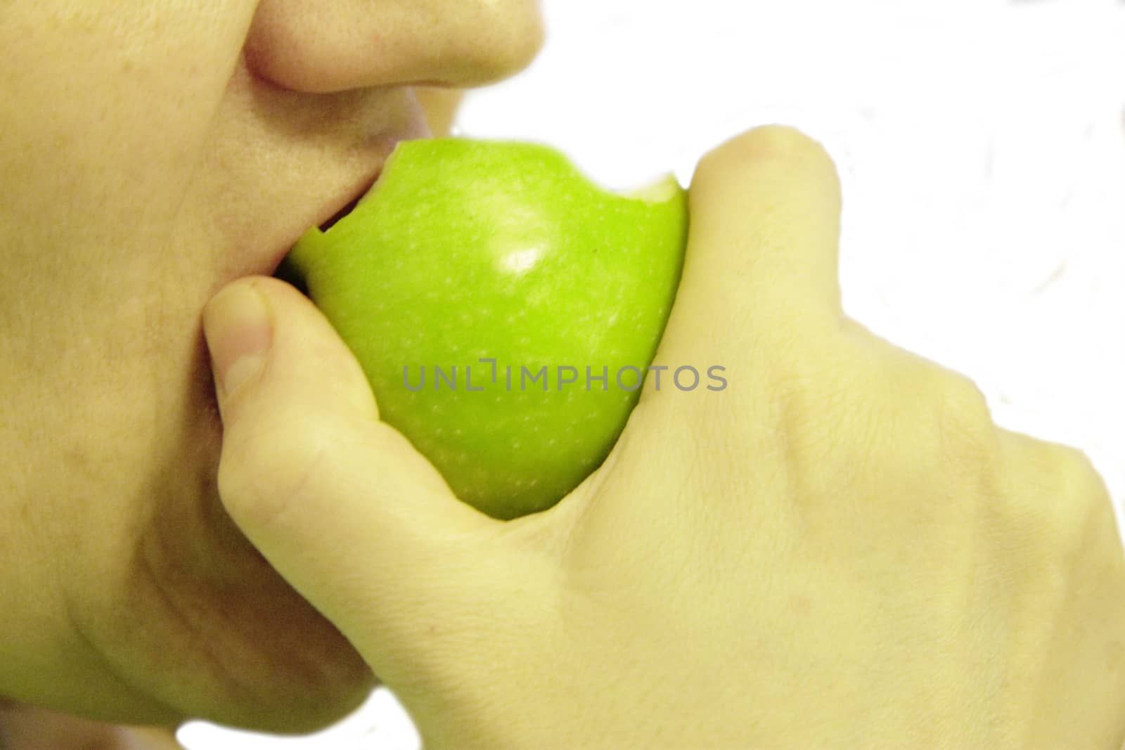 Woman bit a green apple isolated on the white