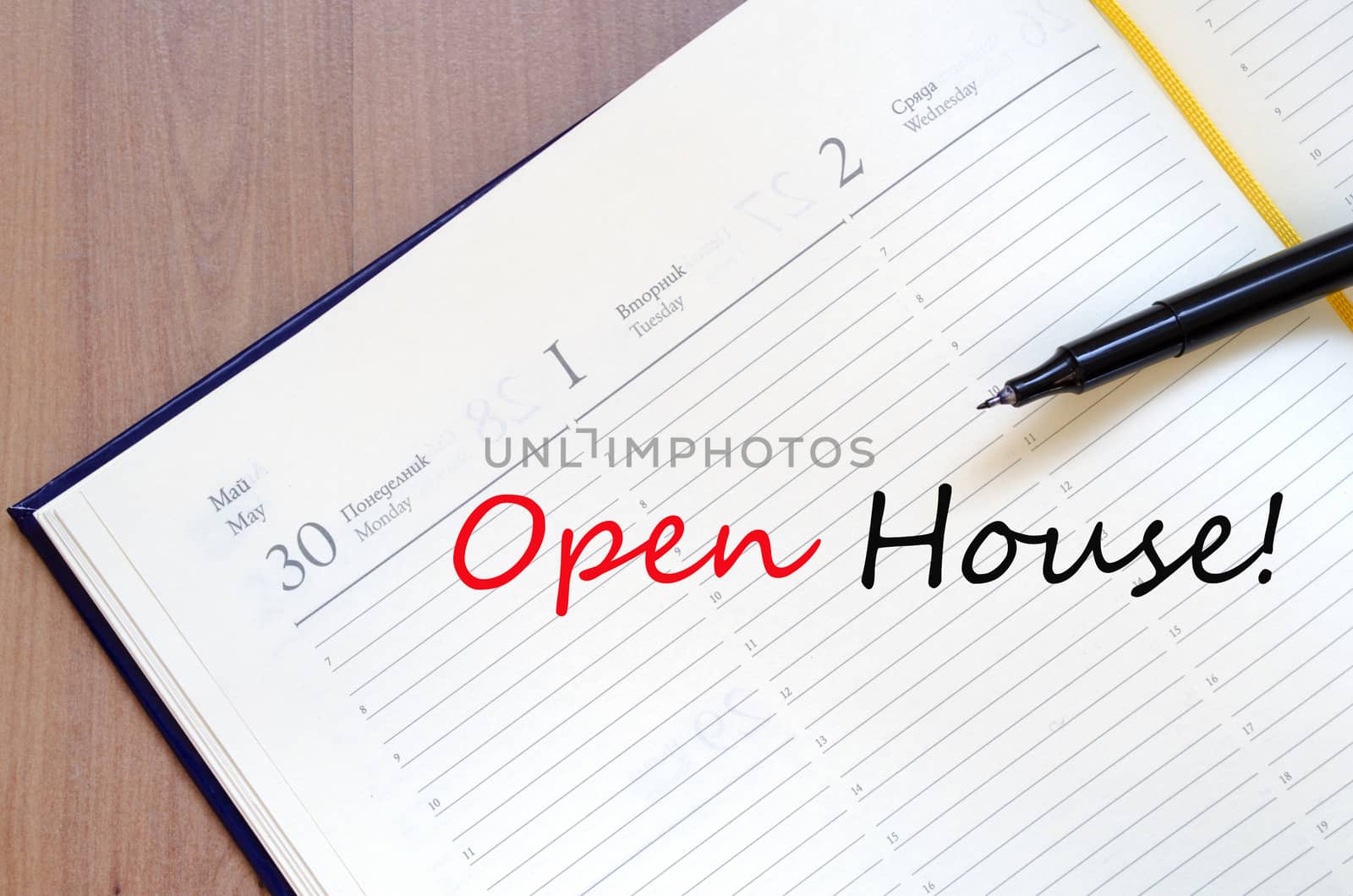 Yellow blank notepad on office wooden table Open house concept