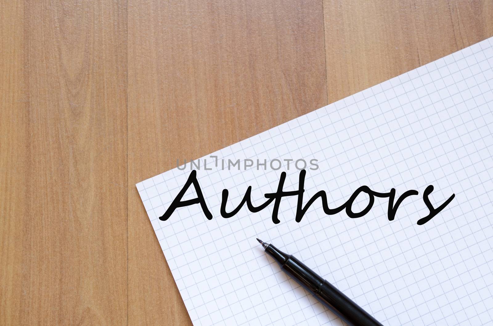 White blank notepad on office wooden table Authors concept