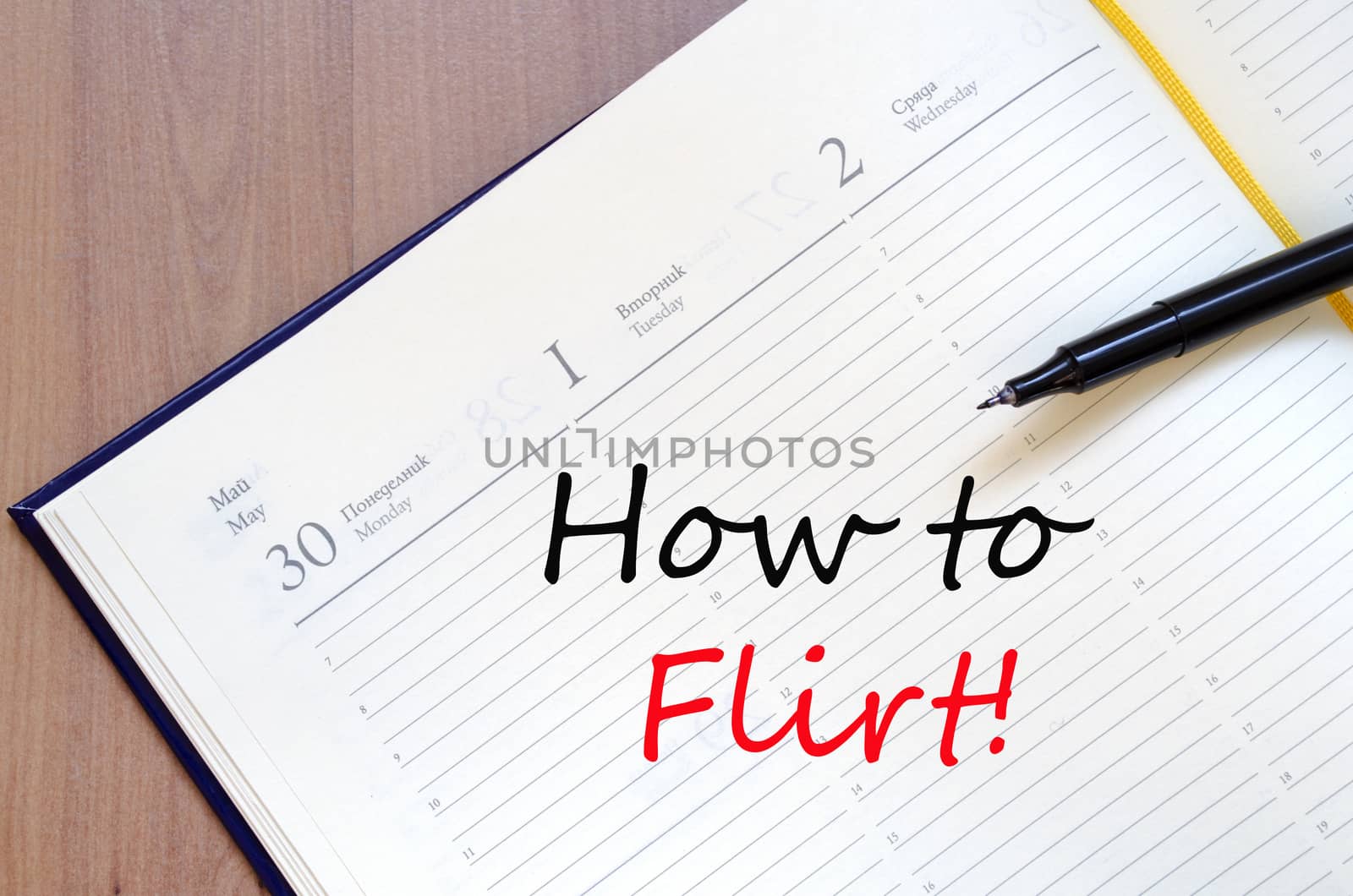 Yellow blank notepad on office wooden table How to flirt concept