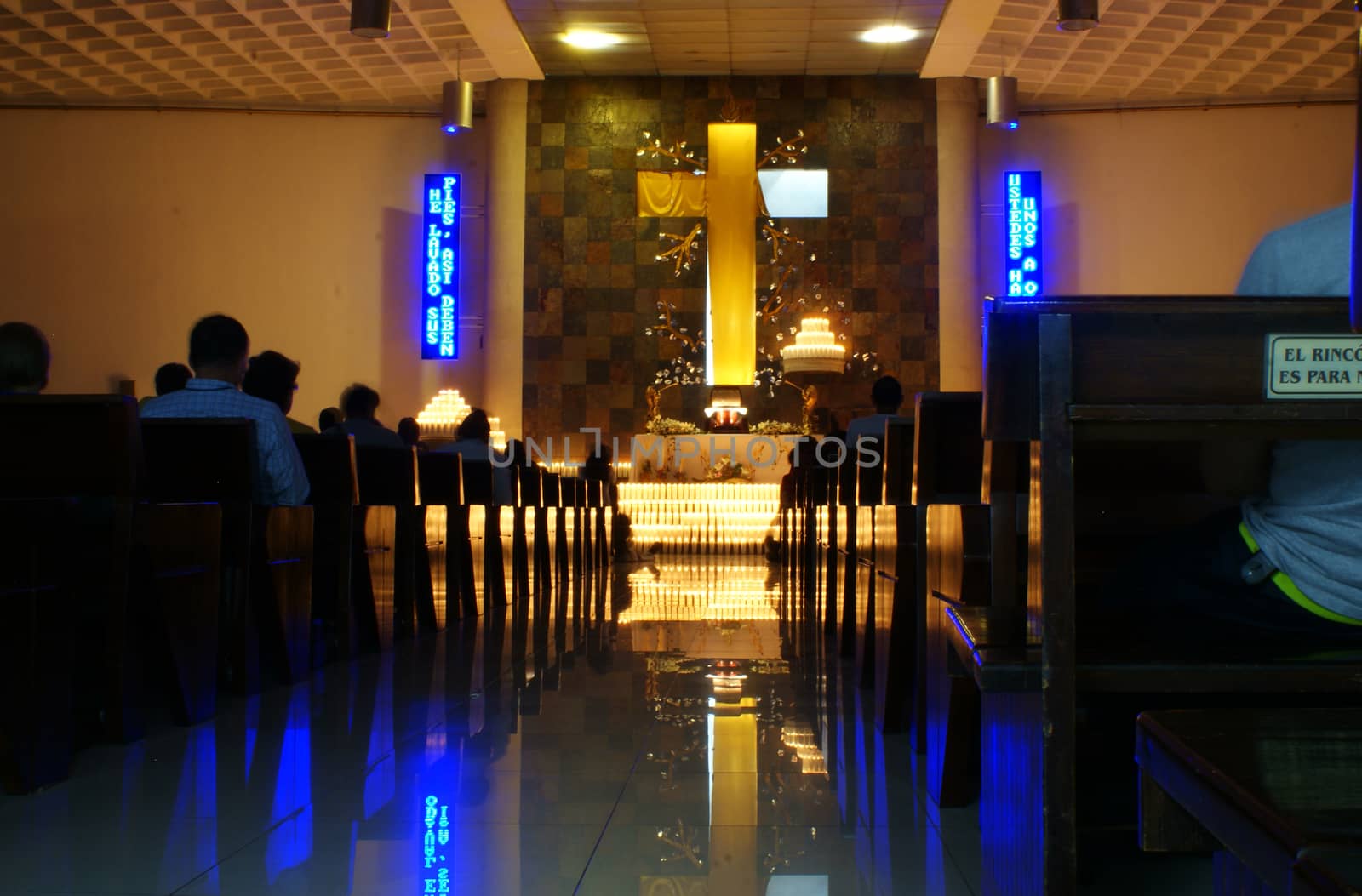 Photograph of a lot of wax candles inside a temple