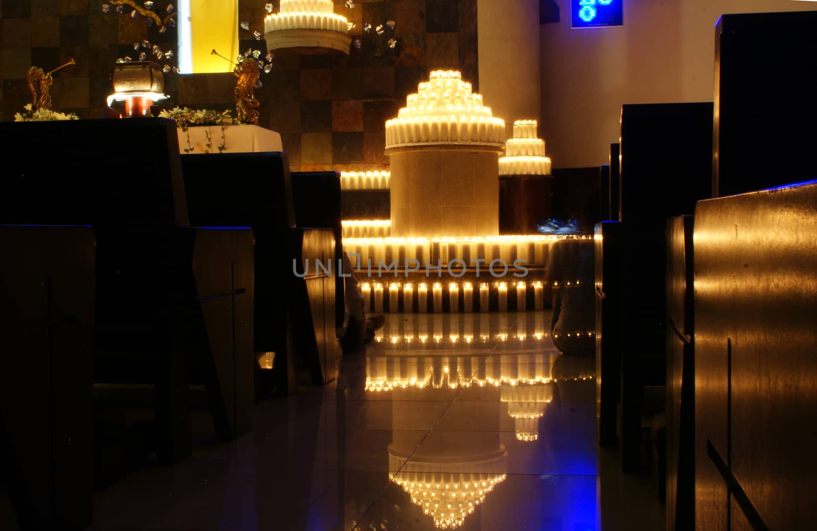 Photograph of a lot of wax candles inside a temple