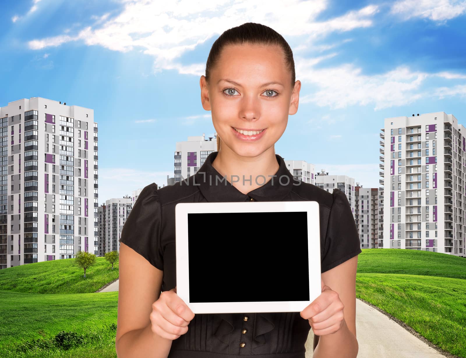 Businesslady holding tablet and cityscape under blue sky with road 