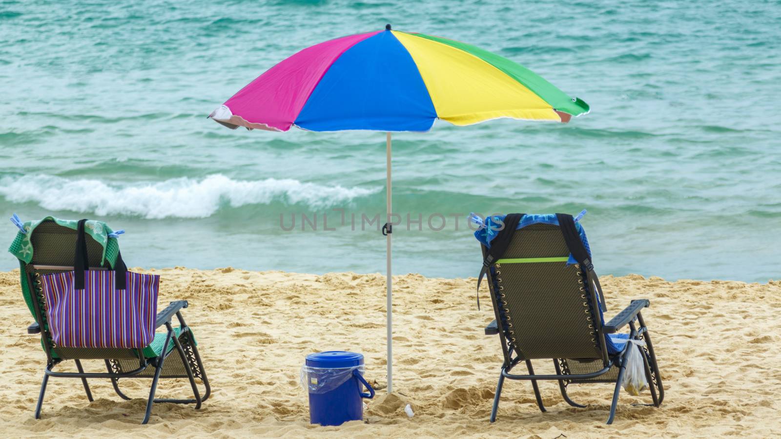 Two deck chairs, parasol and a portable fridge - everything for a relaxing holiday