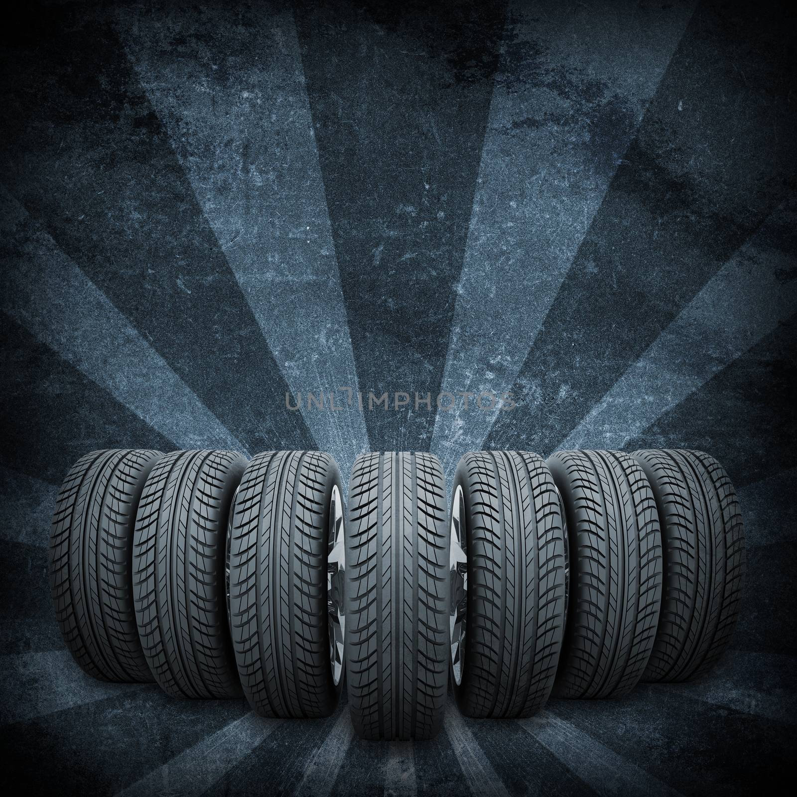 Wedge of new car wheels. Abstract dark background is concrete surface and stripes at bottom