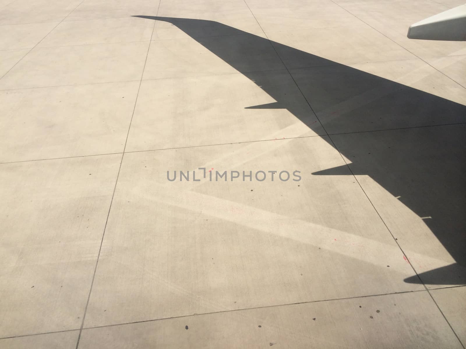 airplane wing shadow on runway by haiderazim