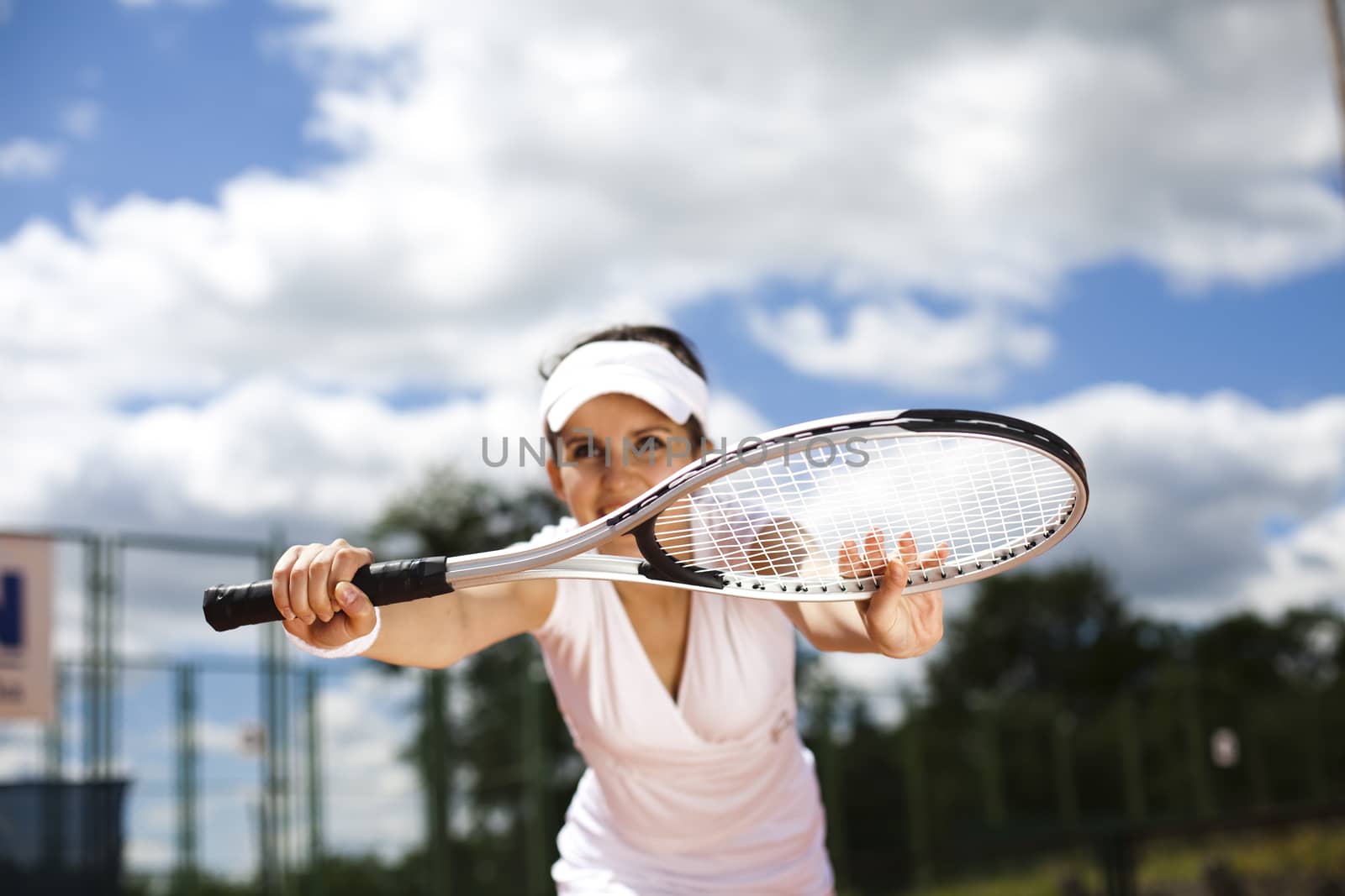 Woman playing tennis in summer