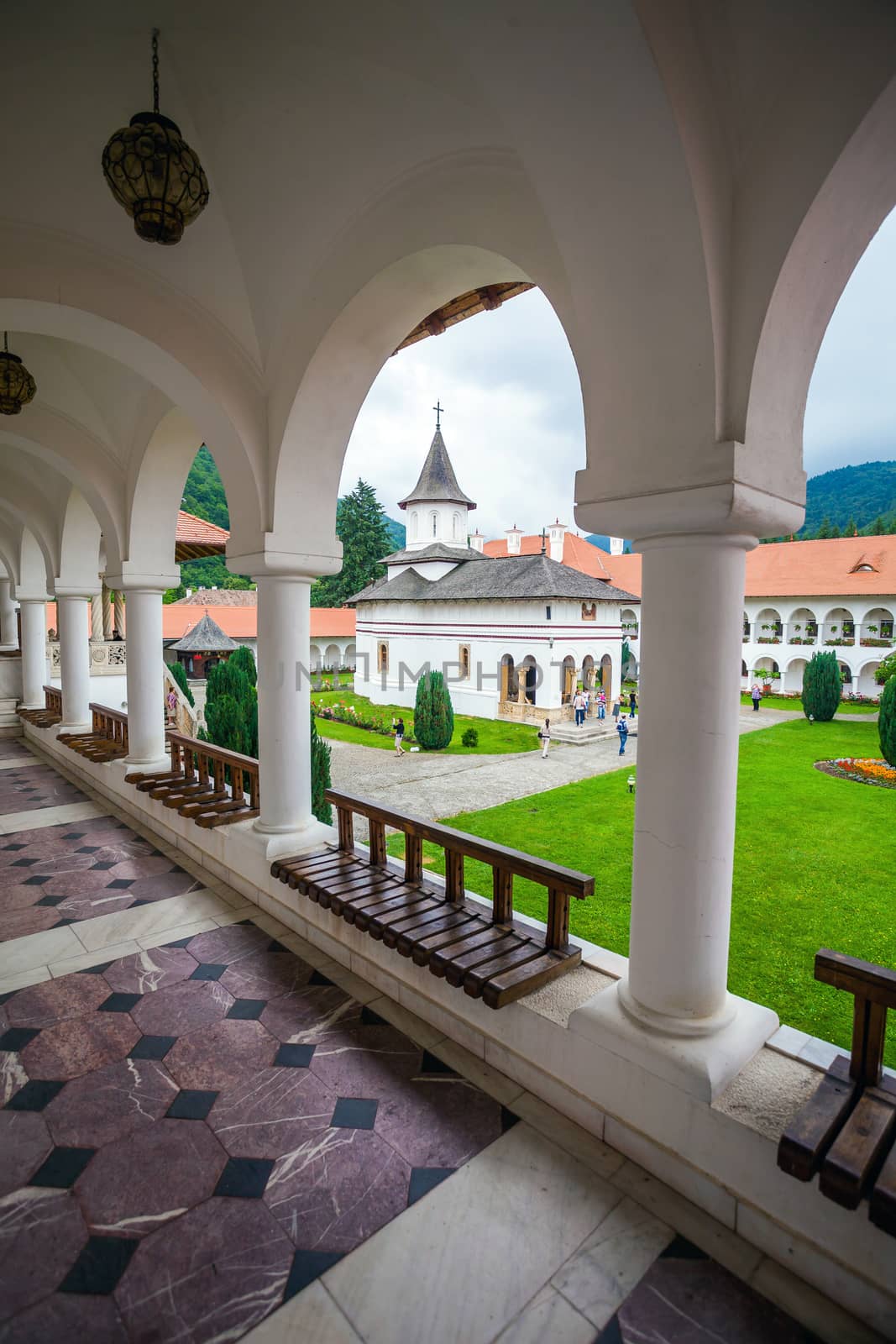Sambata, Romania - June 24, 2012: Church inside Sambata de Sus Monastery seen trough a colonade in Transylvania, Romania