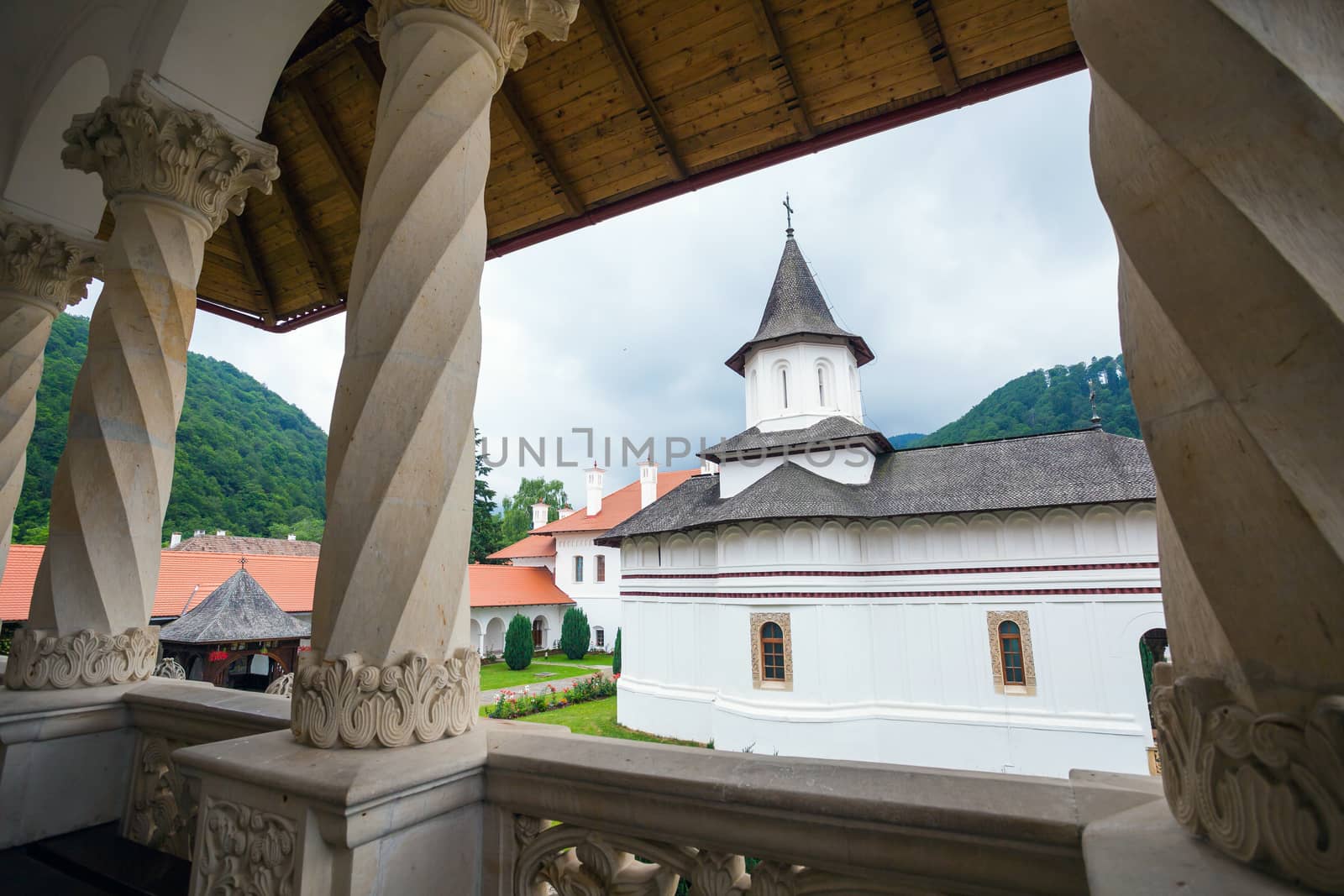 Church inside Sambata de Sus Monastery seen trough a colonade in Transylvania, Romania