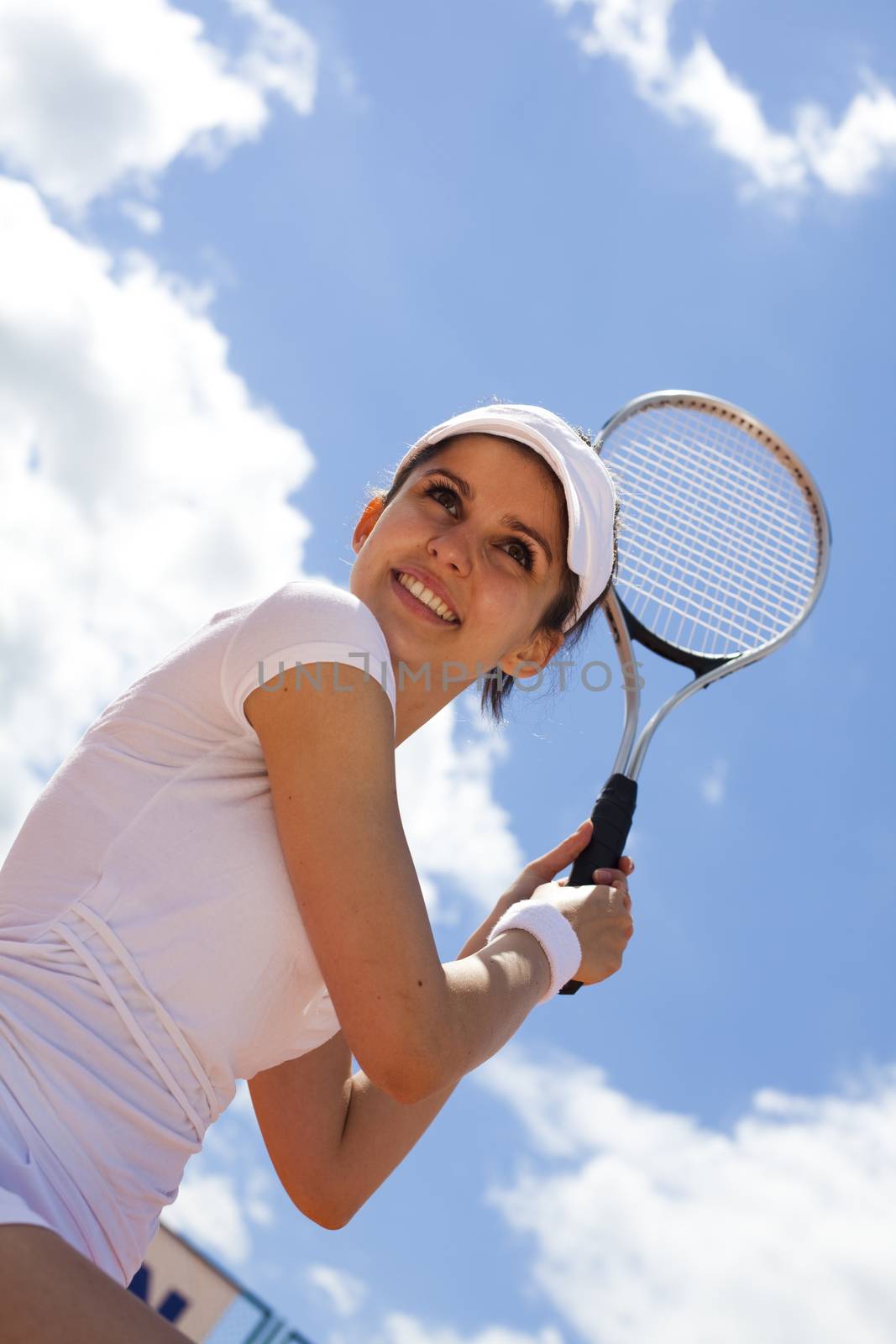 Young woman tennis player on the court by JanPietruszka