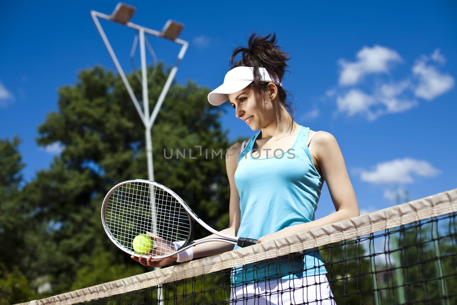 Young woman tennis player on the court