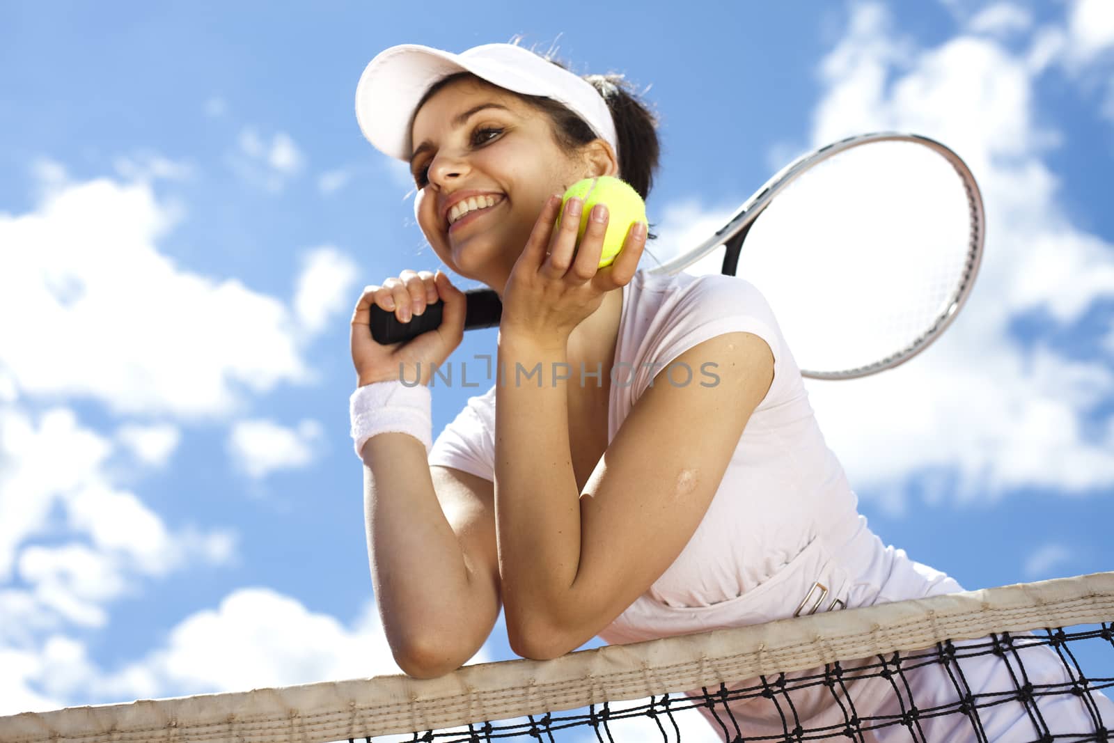 Young woman tennis player on the court