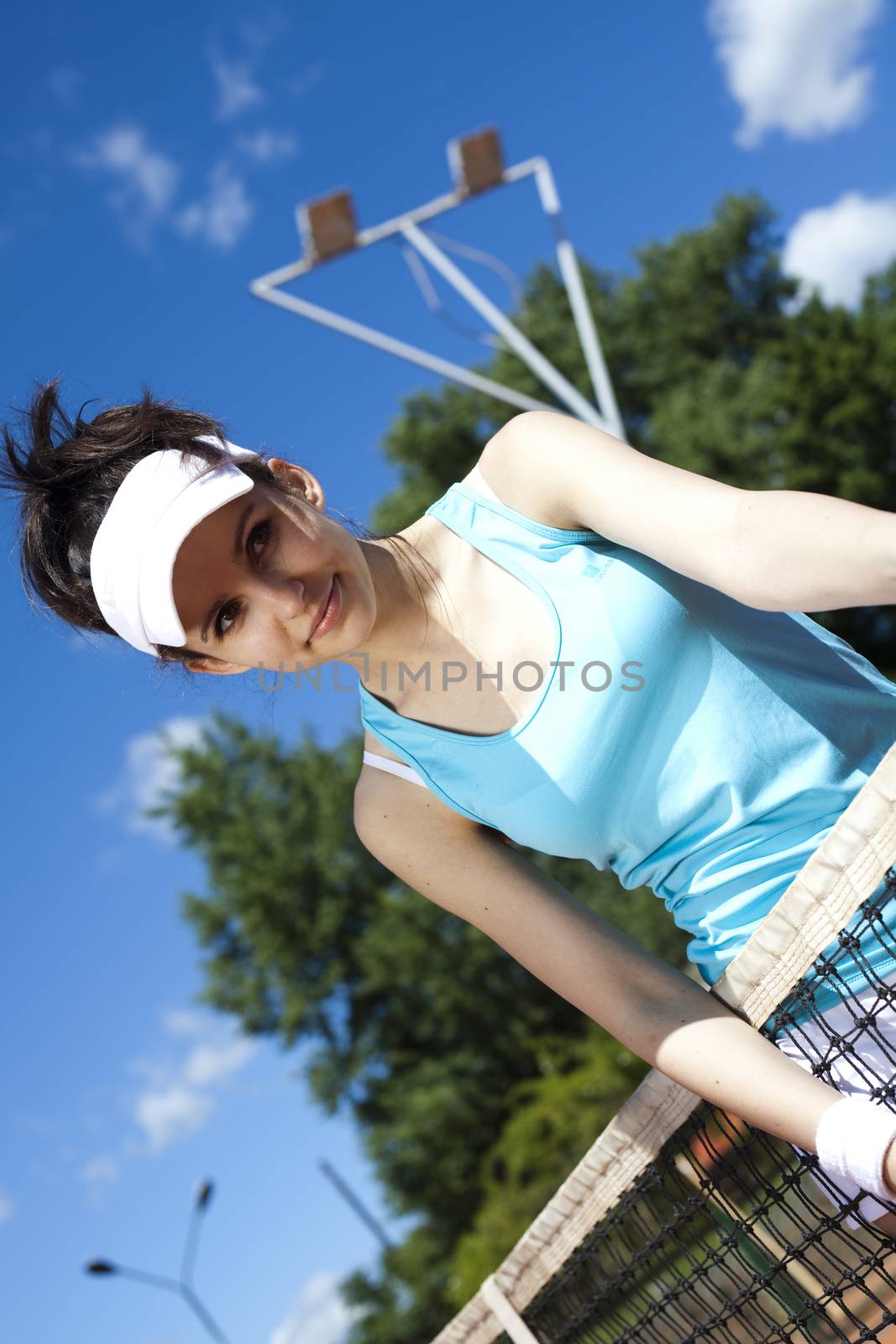 Young woman tennis player on the court