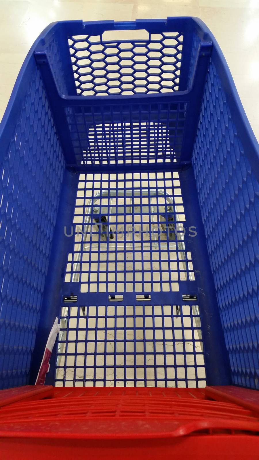 An empty shopping cart in motion in a supermarket
