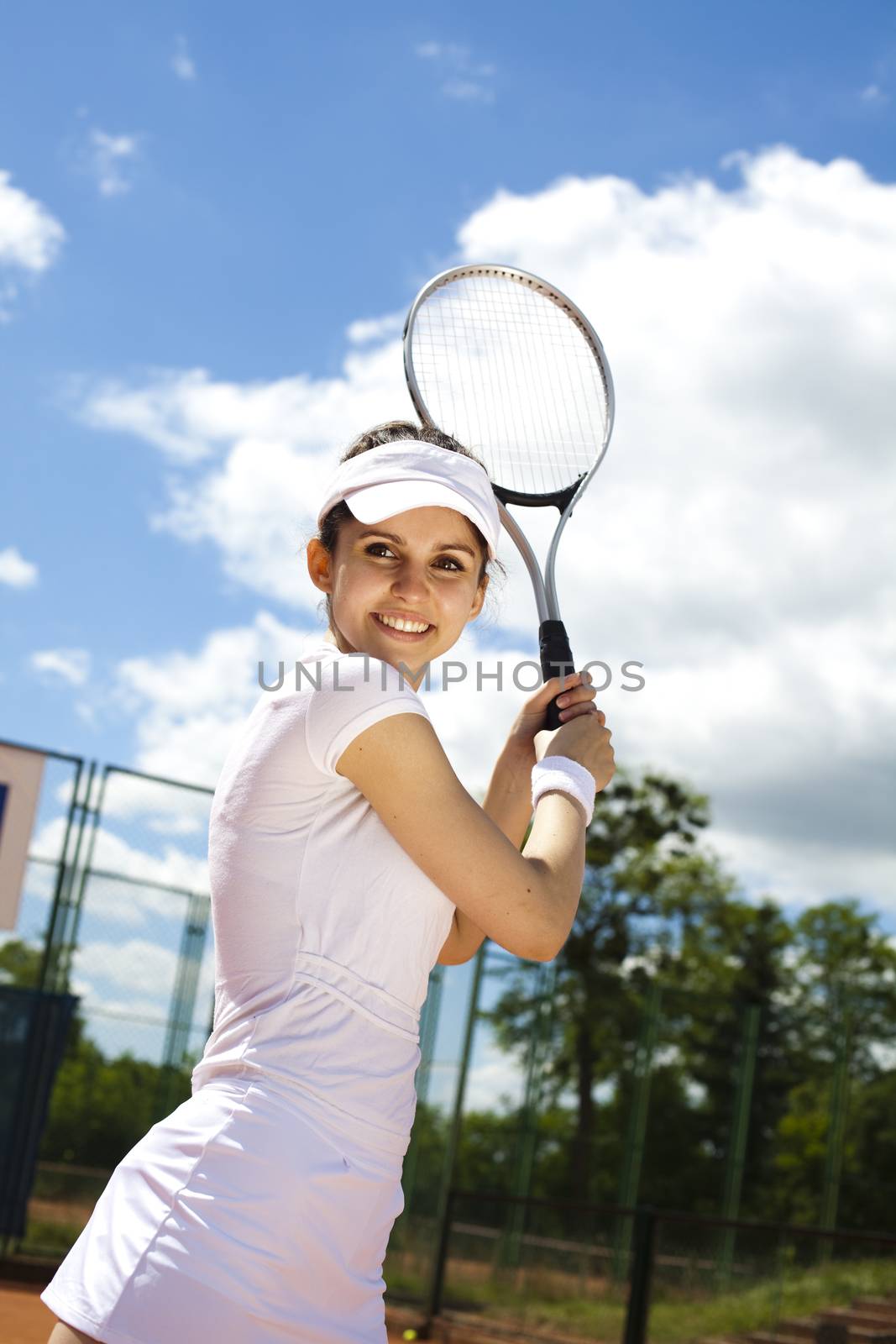 Young woman tennis player on the court by JanPietruszka