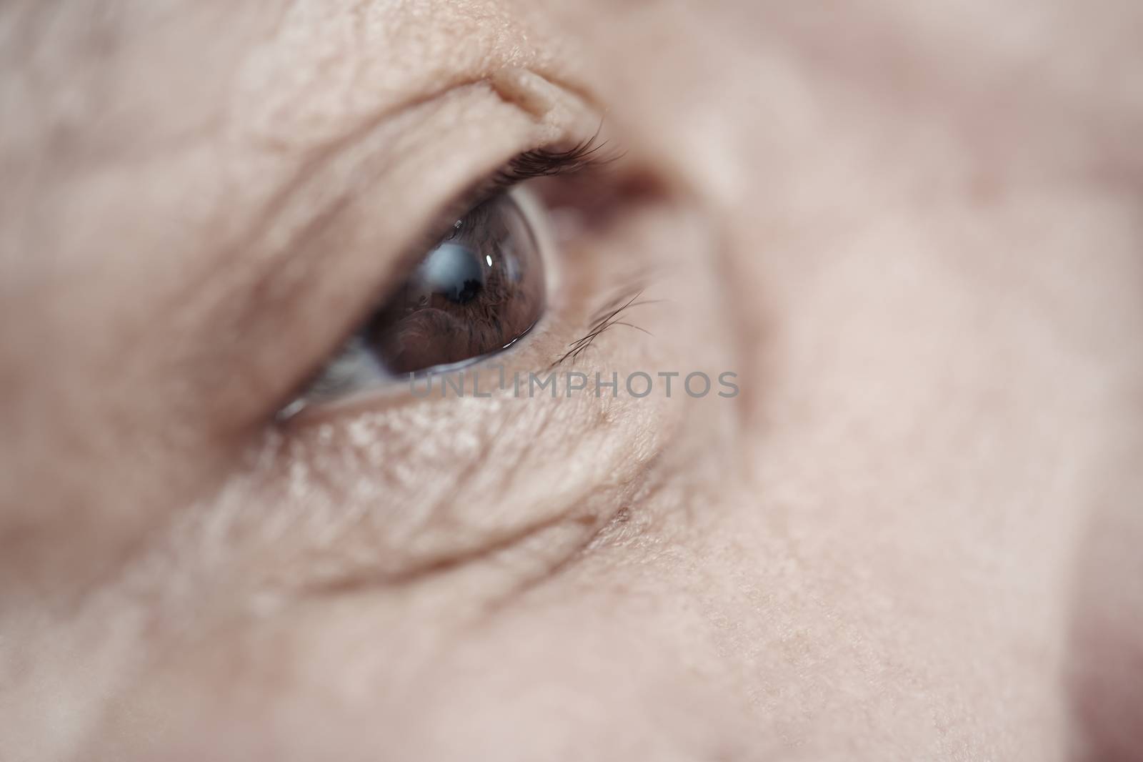 Close-up view on the eye of elderly human
