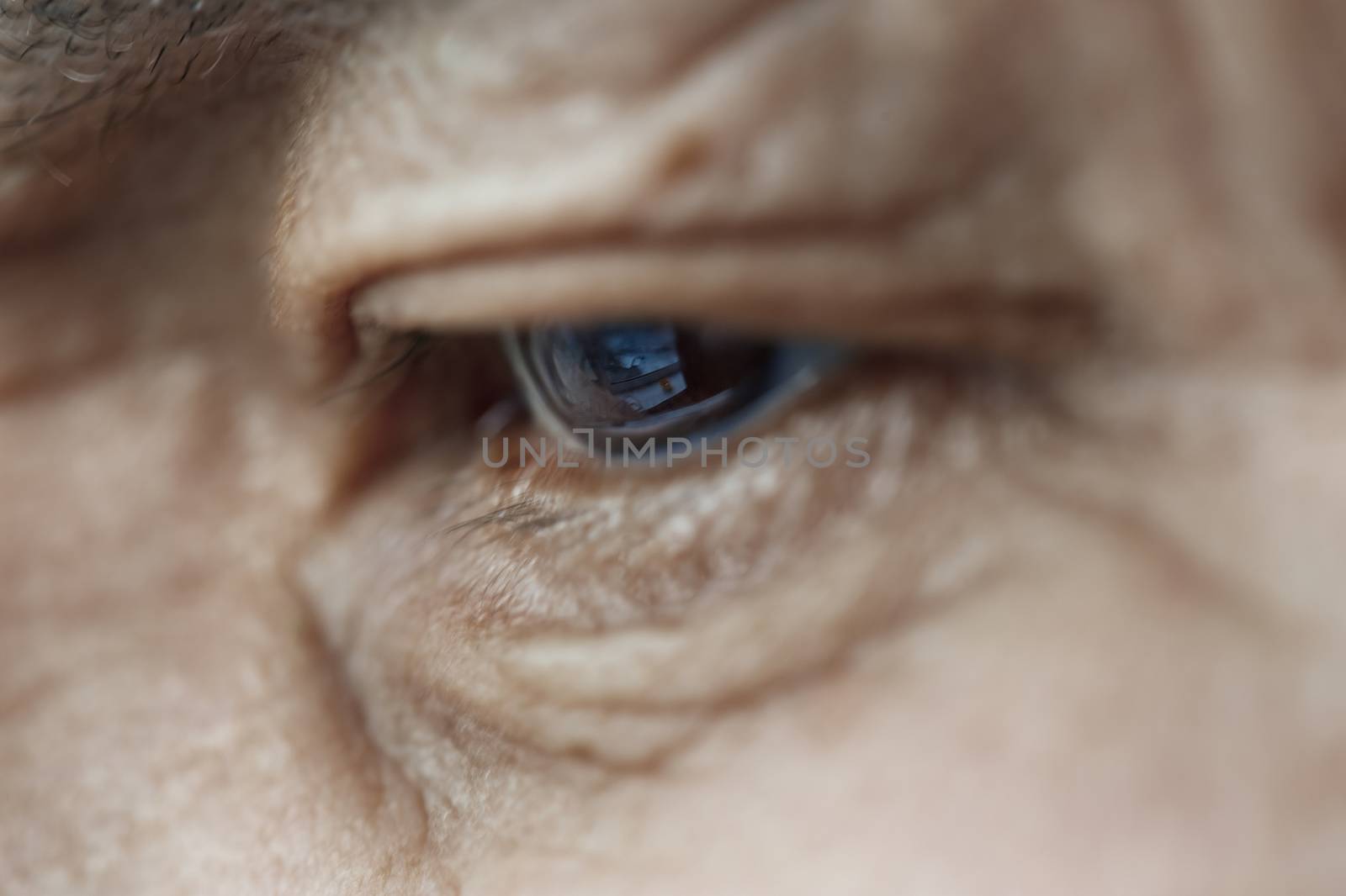 Close-up view on the eye of elderly human