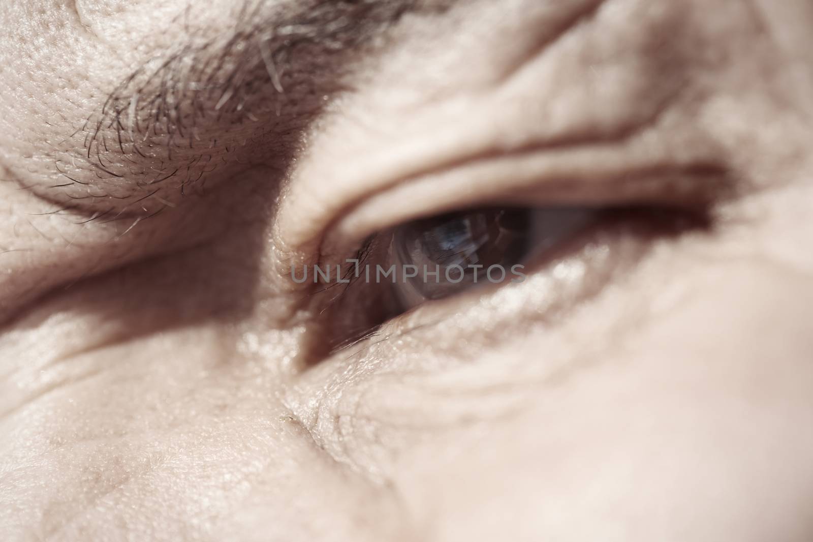 Close-up view on the eye of elderly human