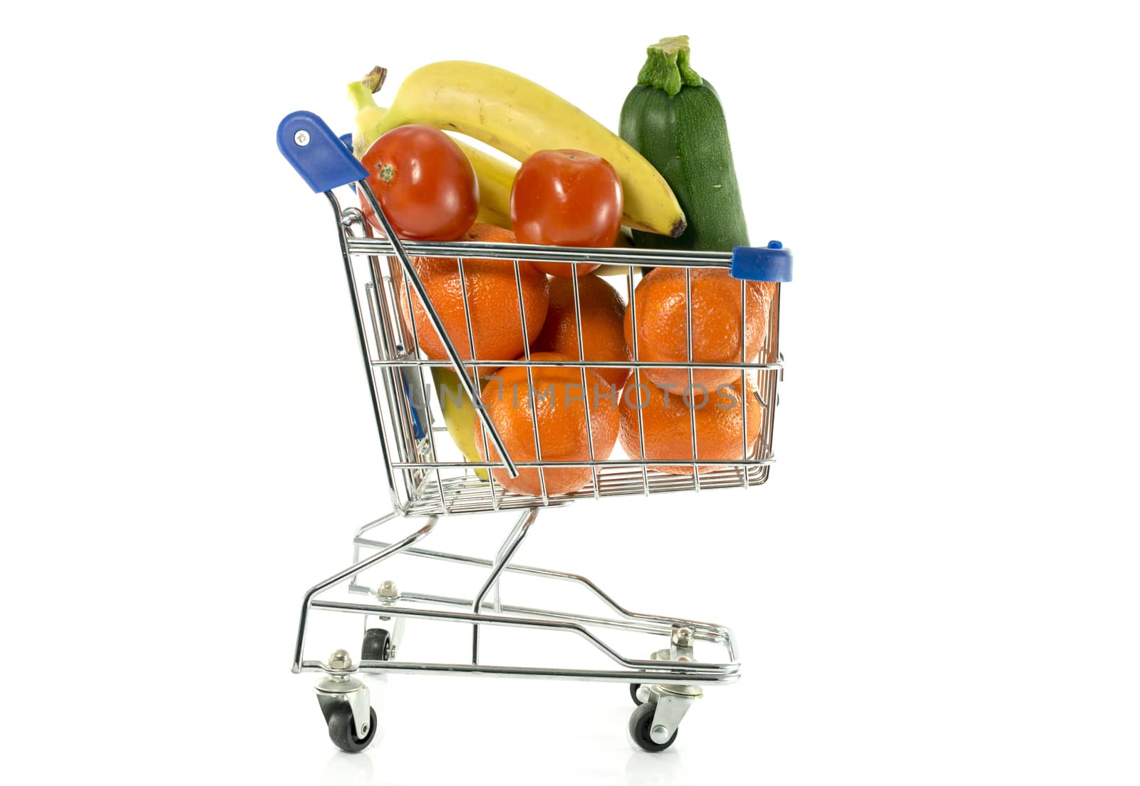 shopping cart with fresh fruit as bananas oranges and red tomatoand green gourgette