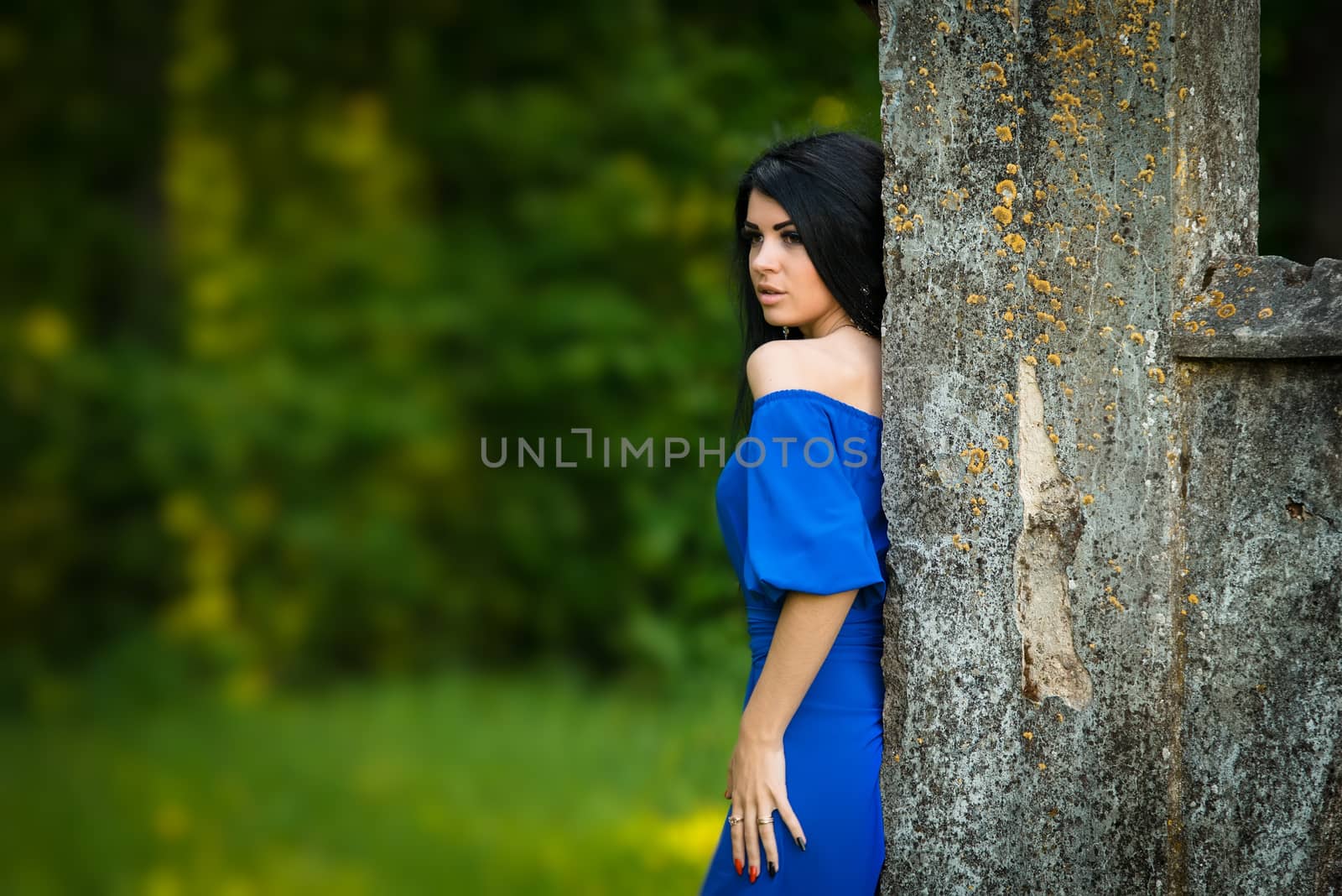 Portrait of sensual fashion young woman in blue dress outdoor