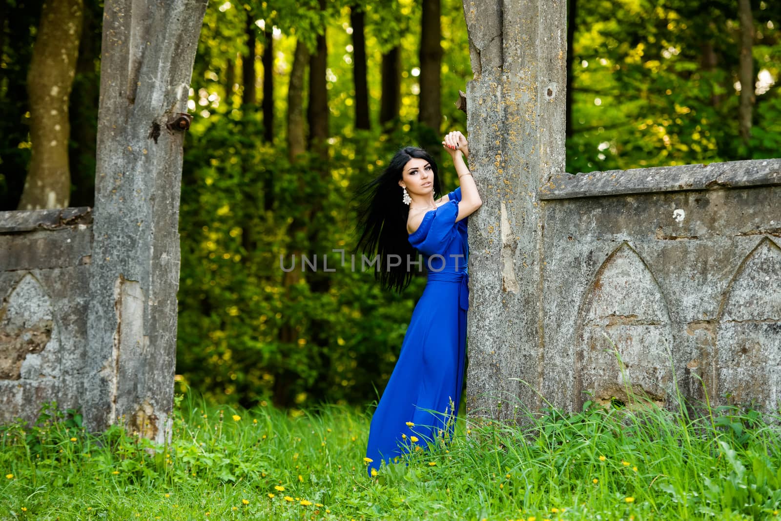 Portrait of sensual fashion young woman in blue dress outdoor