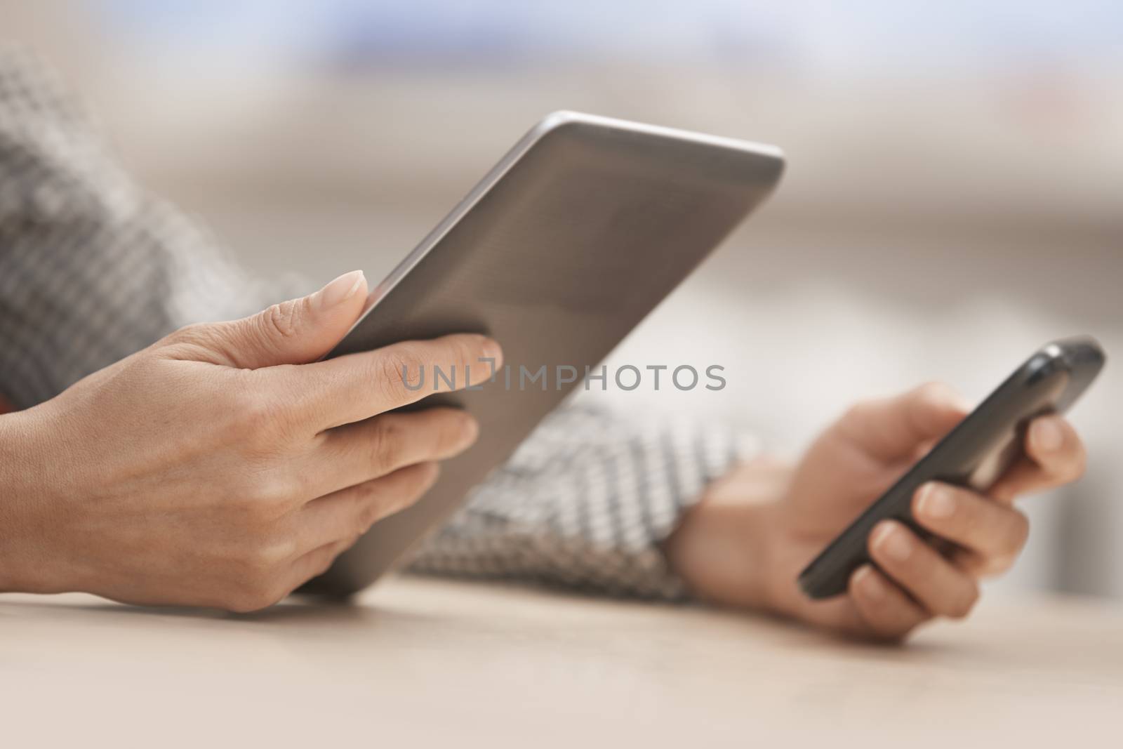 Businesswoman at office with digital tablet and smartphone