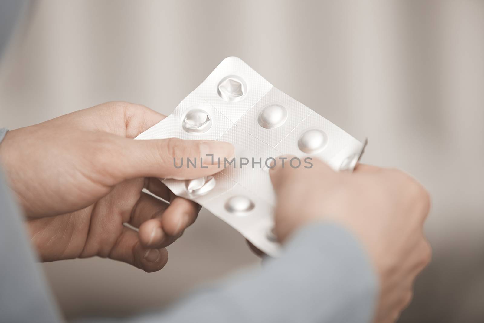 Hands of woman holding pack of medicament