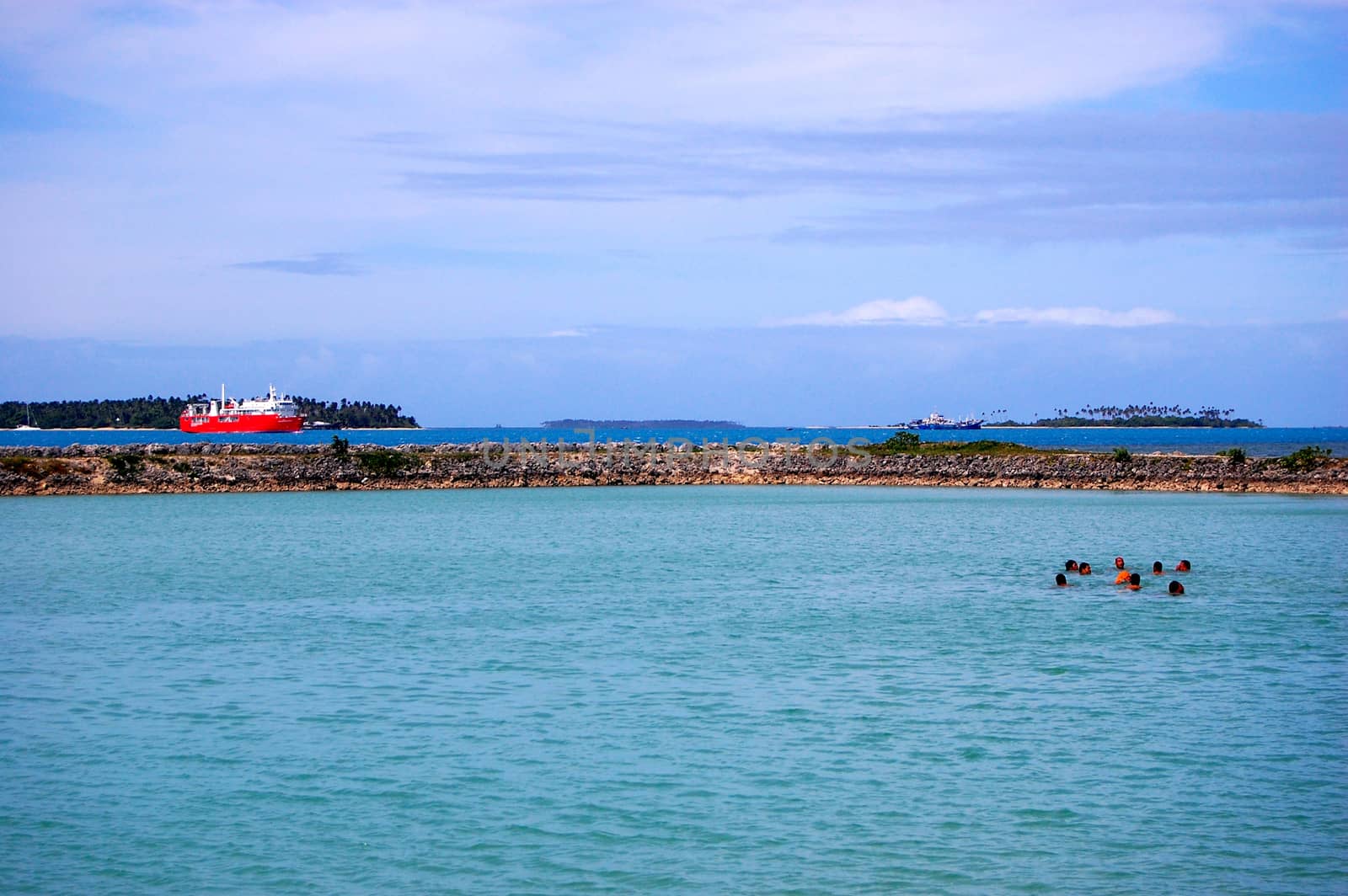 People swimming near port, Tonga, South Pacific