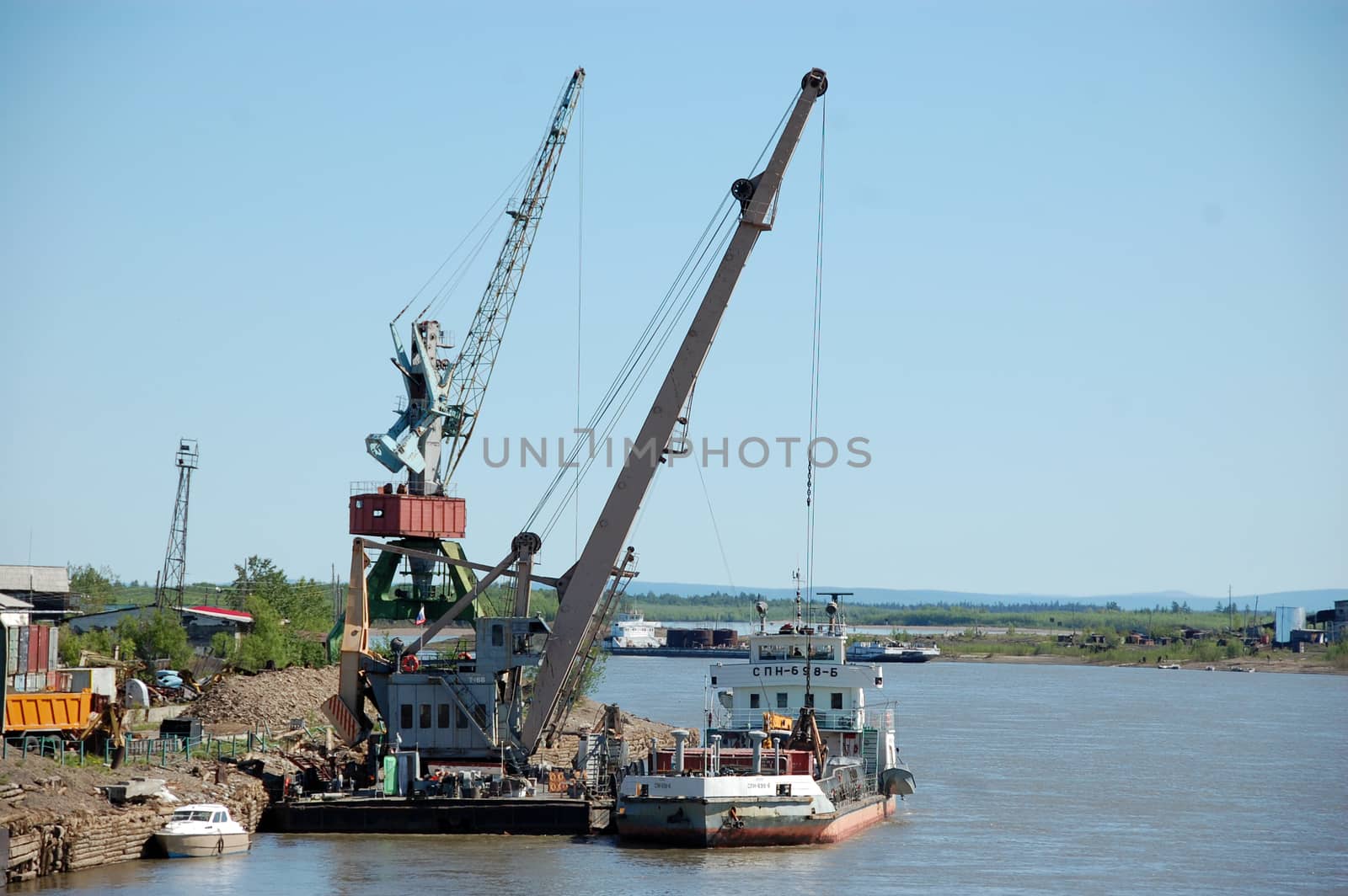 Dockside cargo crane at river port by danemo