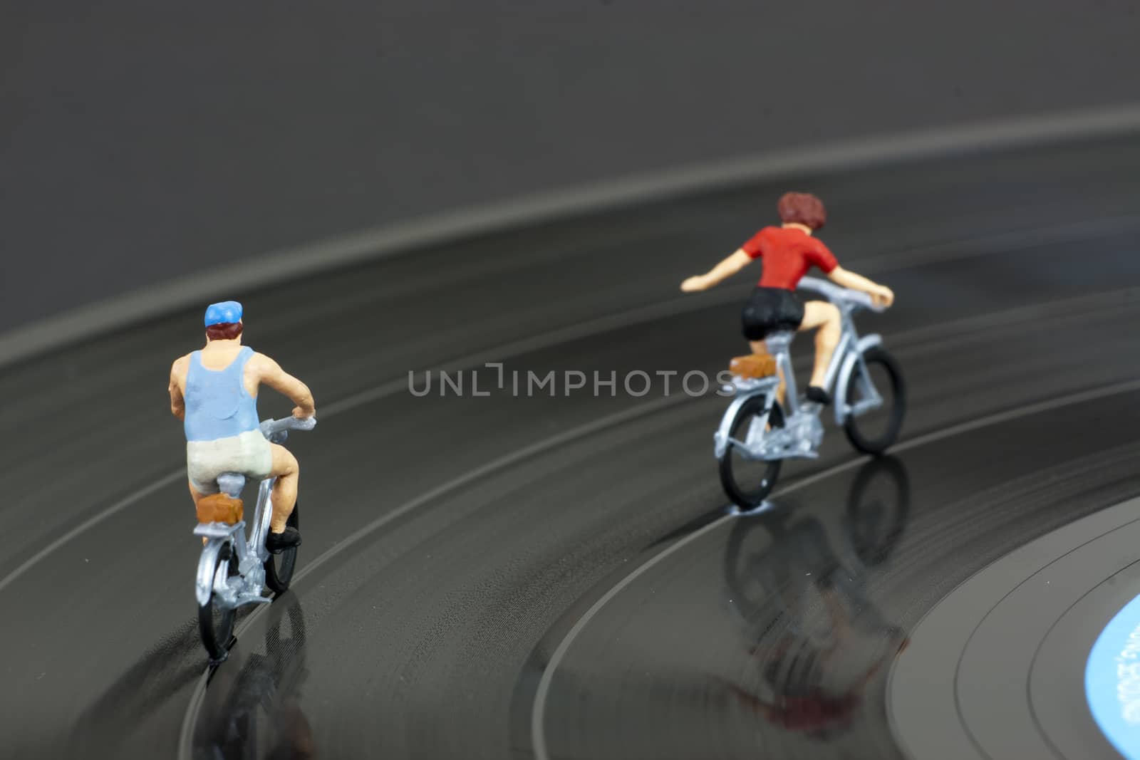 Model people having a cycle race on a record